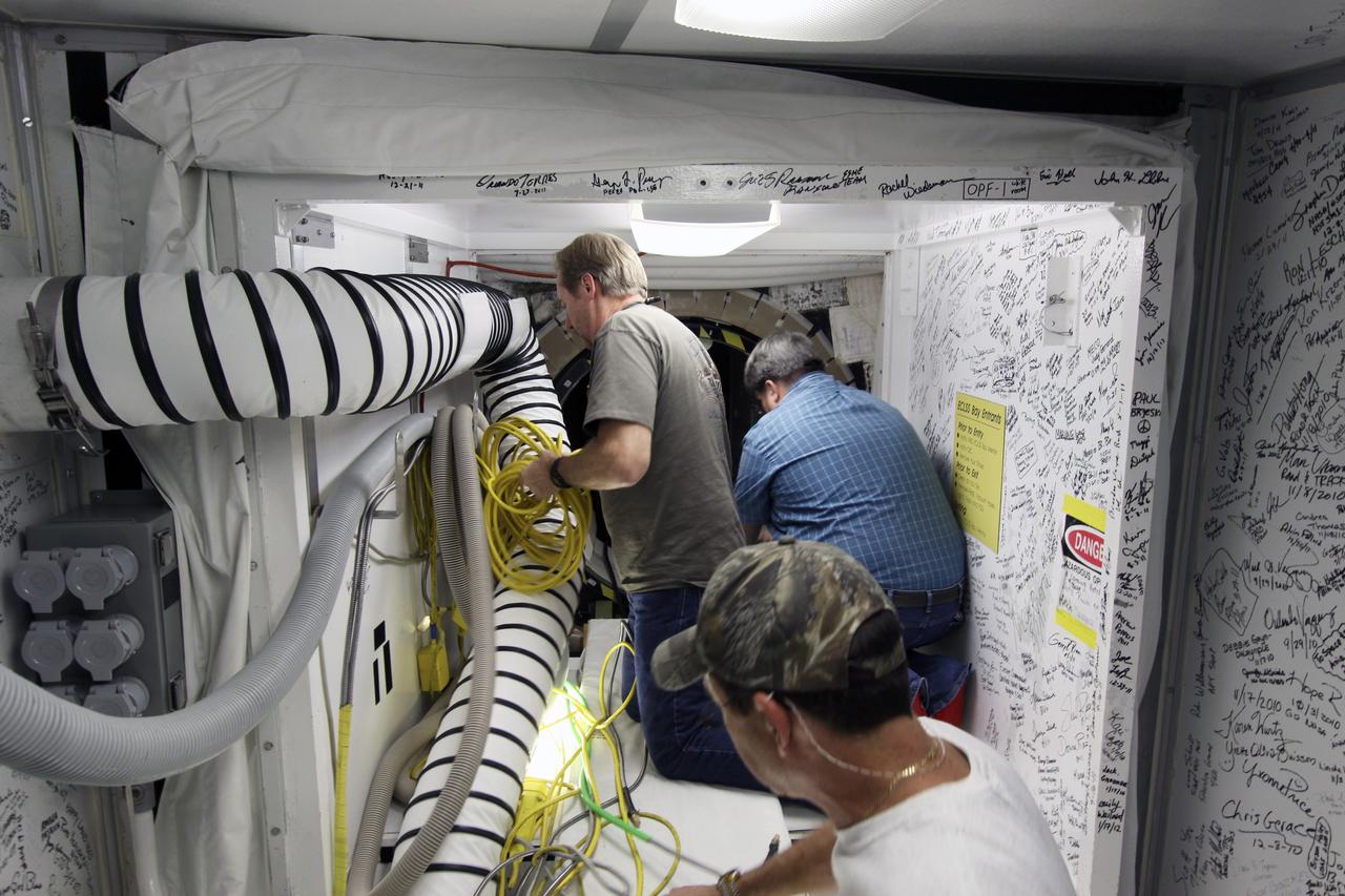 CAPE CANAVERAL, Fla. -- Inside Orbiter Processing Facility-1 at NASA’s Kennedy Space Center in Florida, technicians prepare space shuttle Discovery’s access hatch for final close out.     The work is part of the Space Shuttle Program’s transition and retirement processing of shuttle Discovery, which is being prepared for display at Smithsonian’s National Air and Space Museum, Steven F. Udvar-Hazy Center in Chantilly, Va. Discovery is scheduled to be transported atop a NASA Shuttle Carrier Aircraft modified 747 jet to Dulles International Airport in Virginia on April 17 and then be transported to the Smithsonian on April 19. For more information, visit http://www.nasa.gov/shuttle.  Photo credit: NASA/Jim Grossmann