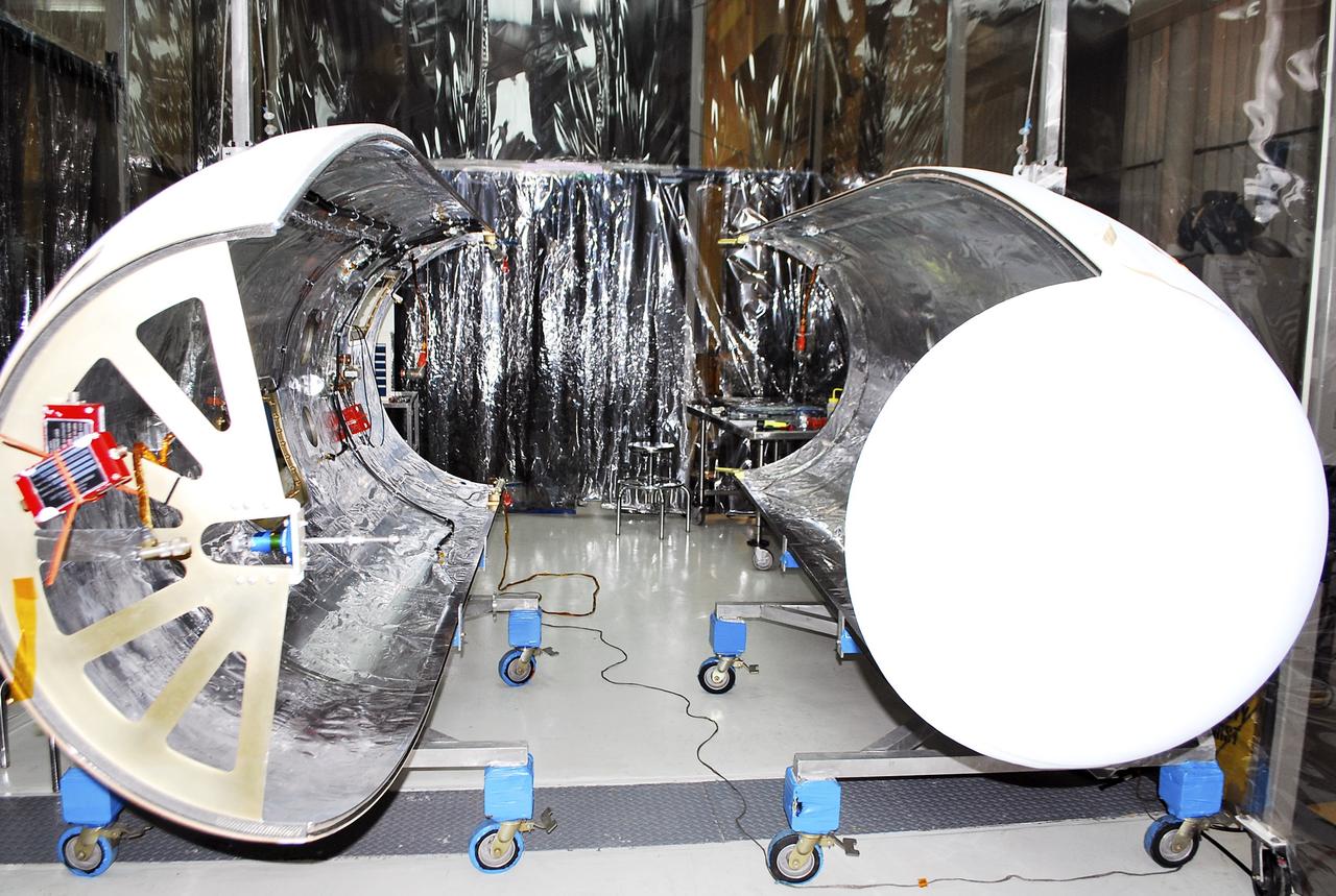 VANDENBERG AIR FORCE BASE, Calif. – The fairing for NASA's Nuclear Spectroscopic Telescope Array, or NuSTAR, awaits processing in an environmental enclosure inside the Orbital Sciences processing facility at Vandenberg Air Force Base in California.     The fairing will enclose and protect the spacecraft from the heat and aerodynamic pressure generated during ascent to orbit aboard an Orbital Sciences Pegasus XL rocket.  After processing of the rocket and spacecraft are complete, they will be flown on Orbital's L-1011 carrier aircraft from Vandenberg to the Ronald Reagan Ballistic Missile Defense Test Site on the Pacific Ocean’s Kwajalein Atoll for launch in March. The high-energy x-ray telescope will conduct a census of black holes, map radioactive material in young supernovae remnants, and study the origins of cosmic rays and the extreme physics around collapsed stars. For more information, visit http://www.nasa.gov/nustar.  Photo credit: NASA/Randy Beaudoin, VAFB