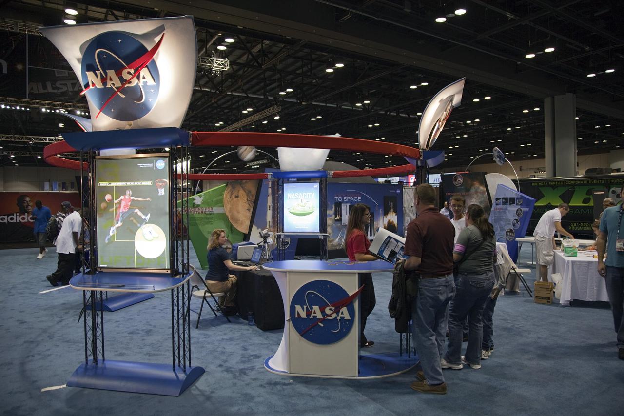 ORLANDO, Fla. -- Inside the Orange County Convention Center in Orlando, Fla., representatives from NASA's Kennedy Space Center in Florida speak to attendees visiting the NBA All-Star Jam Session. The NASA exhibit offers hands-on educational activities highlighting some of the contributions the space agency has made to sports, transportation and everyday life.     One of the events leading up to the NBA All-Star game being held in Orlando on Feb. 26, the NBA All-Star Jam Session is a basketball experience intended for all ages, allowing fans to compete against their friends in skills challenges and collect autographs from players and legends. Photo credit: NASA/Frankie Martin