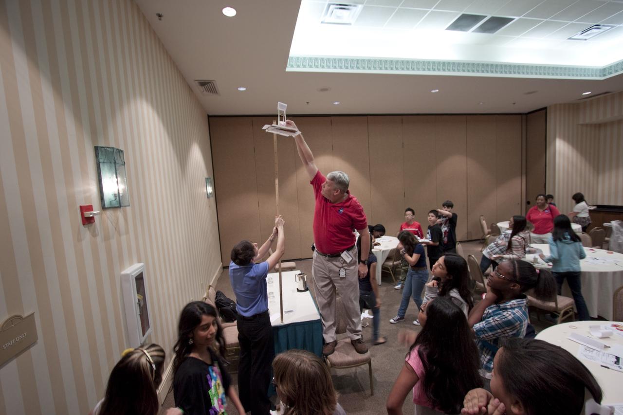 ORLANDO, Fla. – Education specialists from NASA’s Kennedy Space Center set up a physics demonstration for the students from Meadow Woods Middle School in Orlando during NASA’s Project Management PM Challenge 2012.  Here, Jim Gerard, in the red shirt at center, is assisted by Rachel Powers, in the blue shirt.    The demonstrations are designed to increase student interest and pursuit of the science, technology, engineering and mathematics STEM fields integral to producing the next generation of scientists and engineers. PM Challenge 2012 was held at the Caribe Royale Hotel and Convention Center in Orlando, Fla., on Feb. 22-23, to provide a forum for all stakeholders in the project management community to meet and share stories, lessons learned and new uses of technology in the industry. The PM Challenge is sponsored by NASA's Office of the Chief Engineer. For additional information, visit http://www.nasa.gov/offices/oce/pmchallenge/index.html.  Photo credit: NASA/Jim Grossmann