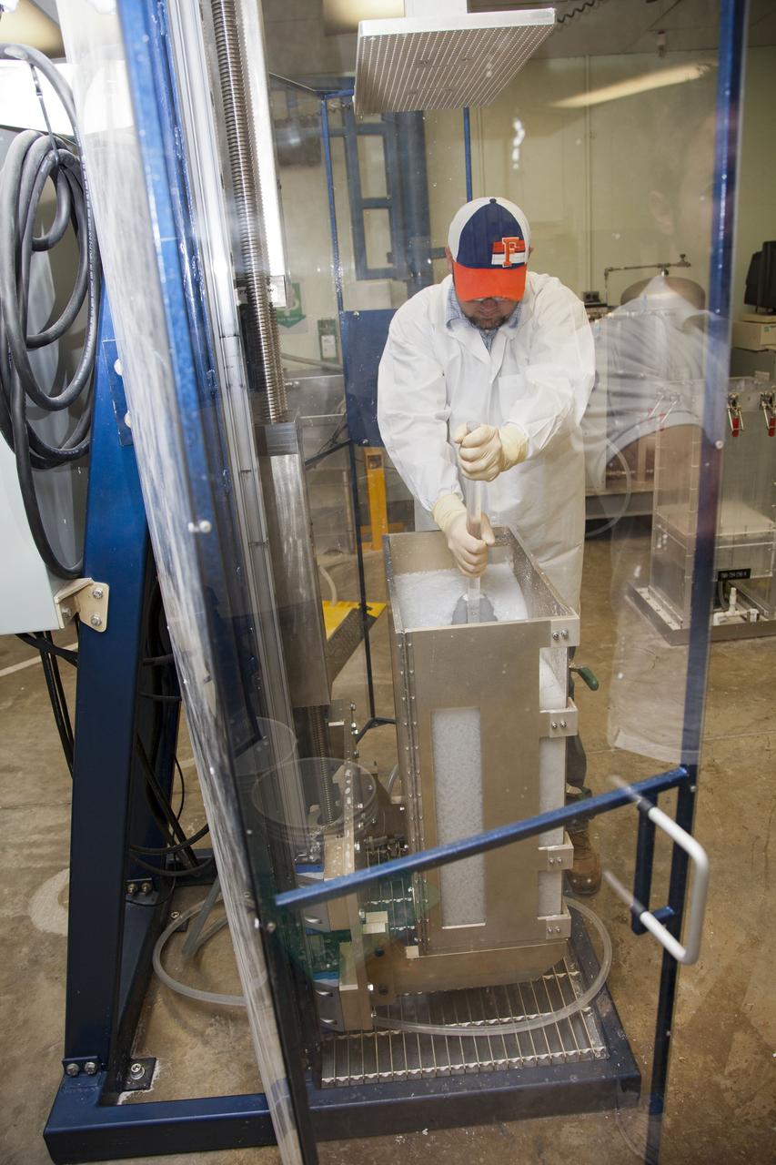 CAPE CANAVERAL, Fla. -- Chris Keeling, a United Space Alliance technician at NASA's Kennedy Space Center in Florida, manufactures the heat shield tiles that will be installed to the backshell of the Orion Multi-Purpose Crew Vehicle's Exploration Flight Test EFT-1 capsule. The work to manufacture and inspect the tiles is taking place in Kennedy's Thermal Protection System Facility. EFT-1 will be used during Orion's first test flight in space. For more information, visit www.nasa.gov/orion. Photo credit: Frankie Martin