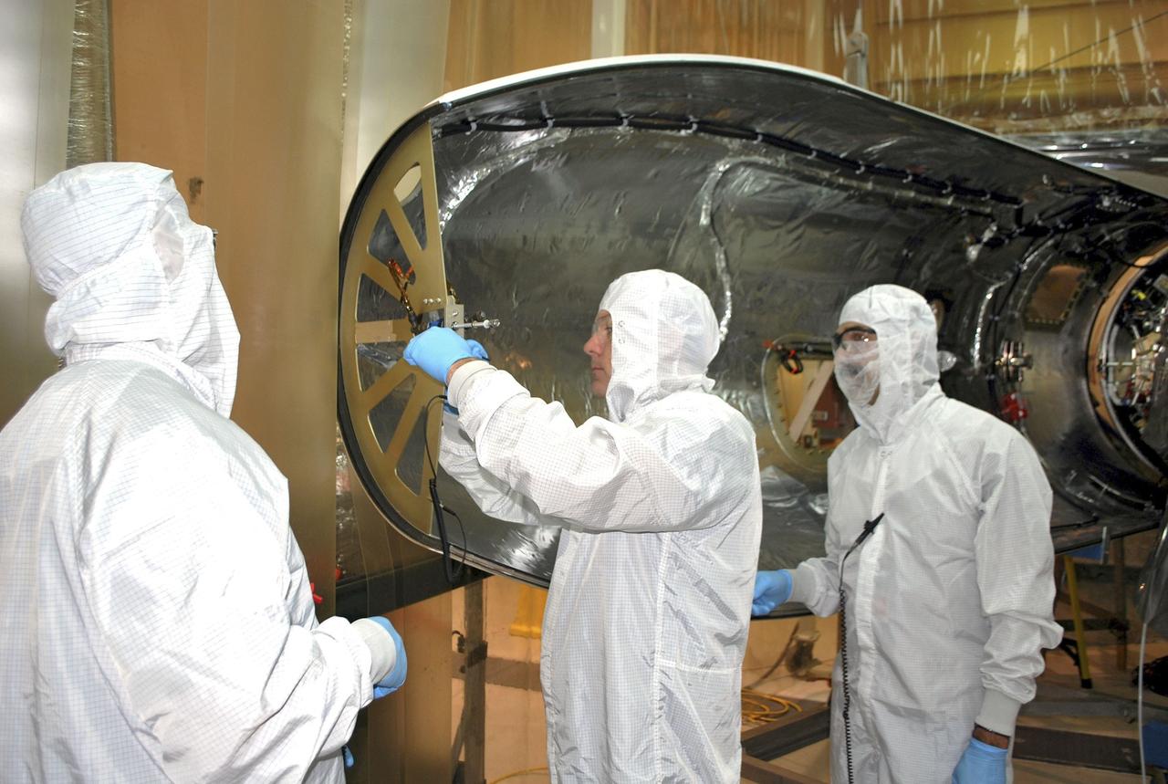 VANDENBERG AIR FORCE BASE, Calif. -- In an environmental enclosure in processing facility 1555 at Vandenberg Air Force Base in California, Orbital Sciences technicians are performing fairing closeouts for NASA's Nuclear Spectroscopic Telescope Array NuSTAR spacecraft. The fairing will protect the spacecraft from the heat and aerodynamic pressure generated during ascent to orbit aboard an Orbital Sciences Pegasus XL rocket. After processing of the rocket and spacecraft are complete, they will be flown on Orbital's L-1011 carrier aircraft from Vandenberg to the Ronald Reagan Ballistic Missile Defense Test Site on the Pacific Ocean’s Kwajalein Atoll for launch. The high-energy X-ray telescope will conduct a census of black holes, map radioactive material in young supernovae remnants, and study the origins of cosmic rays and the extreme physics around collapsed stars. For more information, visit http://www.nasa.gov/nustar. Photo credit: NASA/Randy Beaudoin, VAFB