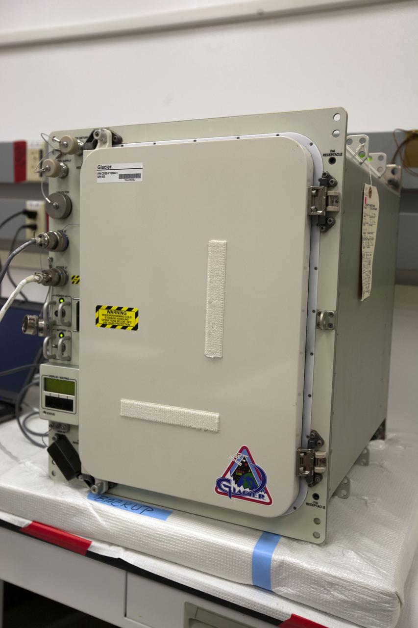 CAPE CANAVERAL, Fla. – Inside the Space Station Processing Facility at NASA’s Kennedy Space Center in Florida, an International Space Station experiment cryogenic freezer called a Glacier unit, is being prepared for transport to Space Launch Complex-40 at Cape Canaveral Air Force Station. The unit is for an experiment late-load demonstration test with the Space Exploration Technologies Corp. SpaceX Falcon 9 rocket and Dragon capsule.     SpaceX is one of two companies under contract with NASA to take cargo to the International Space Station. NASA is working with SpaceX to combine its last two demonstration flights, and if approved, the Falcon 9 would launch the Dragon capsule to the orbiting laboratory for a docking within the next several months. Photo credit: NASA/Amanda Diller