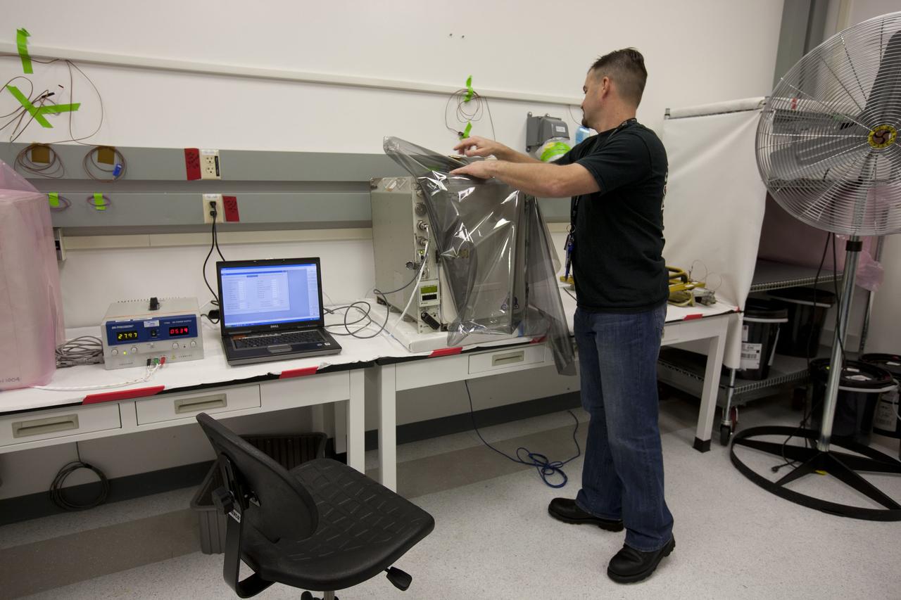 CAPE CANAVERAL, Fla. – Inside the Space Station Processing Facility at NASA’s Kennedy Space Center in Florida, a cold storage team member prepares an International Space Station experiment cryogenic freezer called a Glacier unit, for transport to Space Launch Complex-40 at Cape Canaveral Air Force Station. The unit is for an experiment late-load demonstration test with the Space Exploration Technologies Corp. SpaceX Falcon 9 rocket and Dragon capsule.     SpaceX is one of two companies under contract with NASA to take cargo to the International Space Station. NASA is working with SpaceX to combine its last two demonstration flights, and if approved, the Falcon 9 would launch the Dragon capsule to the orbiting laboratory for a docking within the next several months. Photo credit: NASA/Amanda Diller