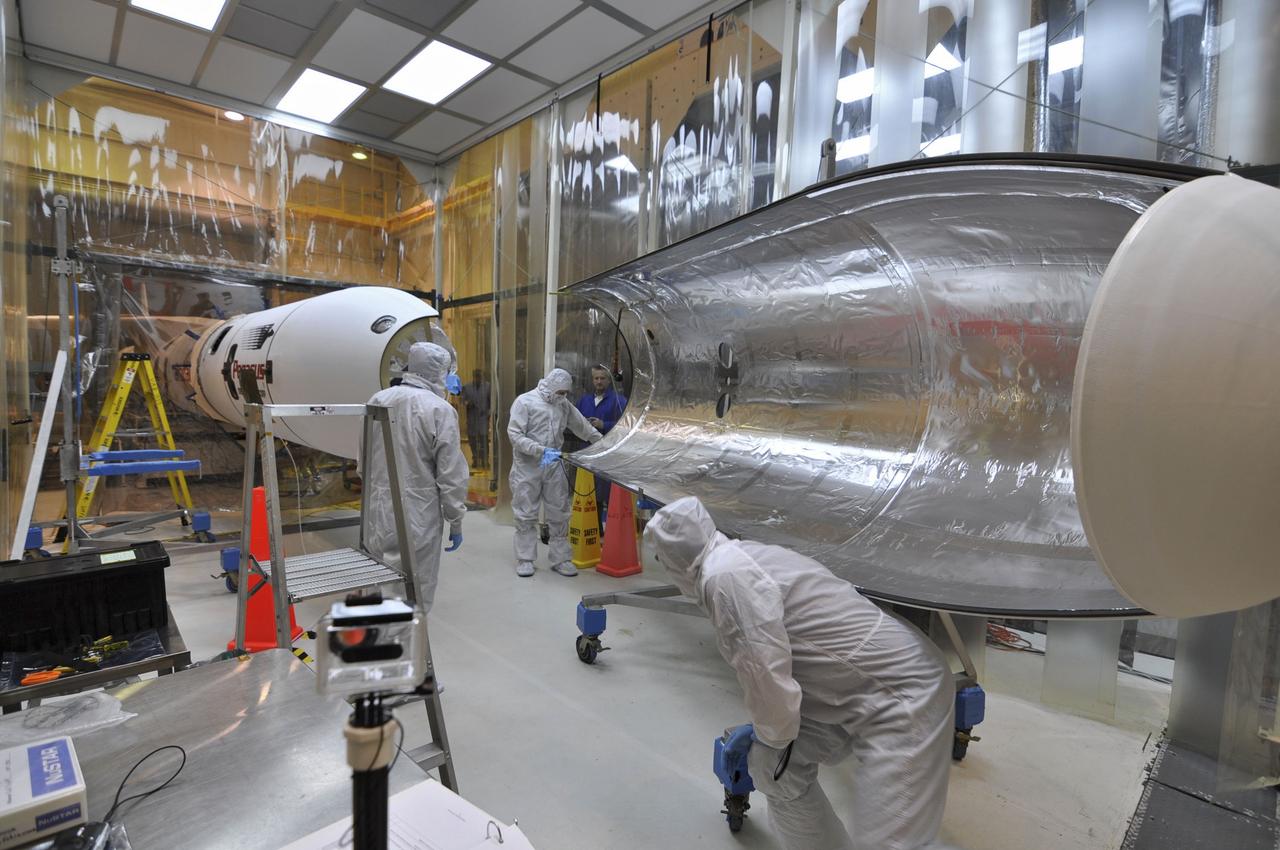 VANDENBERG AIR FORCE BASE, Calif. –The installation of the second section of the Pegasus payload fairing around NASA's Nuclear Spectroscopic Telescope Array, or NuSTAR, is in progress inside the Orbital Sciences processing facility at Vandenberg Air Force Base in California. NuSTAR already is mated to its Pegasus XL rocket, which is positioned outside the environmental enclosure, at left. Encapsulation of NuSTAR in its fairing is a significant prelaunch milestone. The fairing will protect the spacecraft from the heat and aerodynamic pressure generated during ascent to orbit. After processing of the rocket and spacecraft are complete, they will be flown on Orbital's L-1011 carrier aircraft from Vandenberg to the Ronald Reagan Ballistic Missile Defense Test Site on the Pacific Ocean’s Kwajalein Atoll for launch in March. The high-energy x-ray telescope will conduct a census of black holes, map radioactive material in young supernovae remnants, and study the origins of cosmic rays and the extreme physics around collapsed stars. For more information, visit http://www.nasa.gov/nustar. Photo credit: NASA/Randy Beaudoin, VAFB