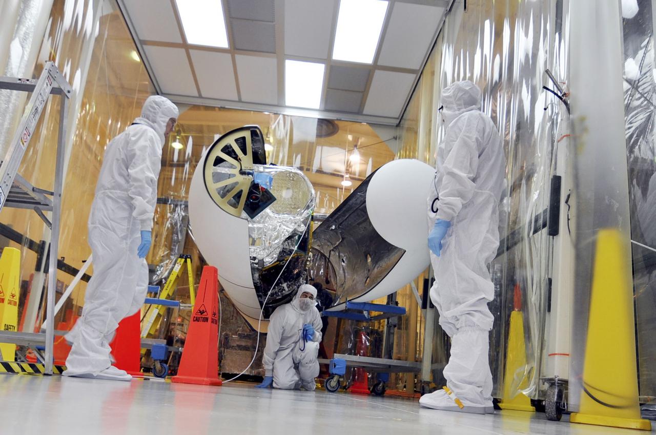 VANDENBERG AIR FORCE BASE, Calif. – Orbital Sciences technicians closely monitor the second section of the Pegasus payload fairing before it is secured around NASA's Nuclear Spectroscopic Telescope Array, or NuSTAR, inside the Orbital Sciences processing facility at Vandenberg Air Force Base in California. NuSTAR already is mated to its Pegasus XL rocket, which is positioned behind the spacecraft outside the environmental enclosure. Encapsulation of NuSTAR in its fairing is a significant prelaunch milestone. The fairing will protect the spacecraft from the heat and aerodynamic pressure generated during ascent to orbit. After processing of the rocket and spacecraft are complete, they will be flown on Orbital's L-1011 carrier aircraft from Vandenberg to the Ronald Reagan Ballistic Missile Defense Test Site on the Pacific Ocean’s Kwajalein Atoll for launch in March. The high-energy x-ray telescope will conduct a census of black holes, map radioactive material in young supernovae remnants, and study the origins of cosmic rays and the extreme physics around collapsed stars. For more information, visit http://www.nasa.gov/nustar. Photo credit: NASA/Randy Beaudoin, VAFB