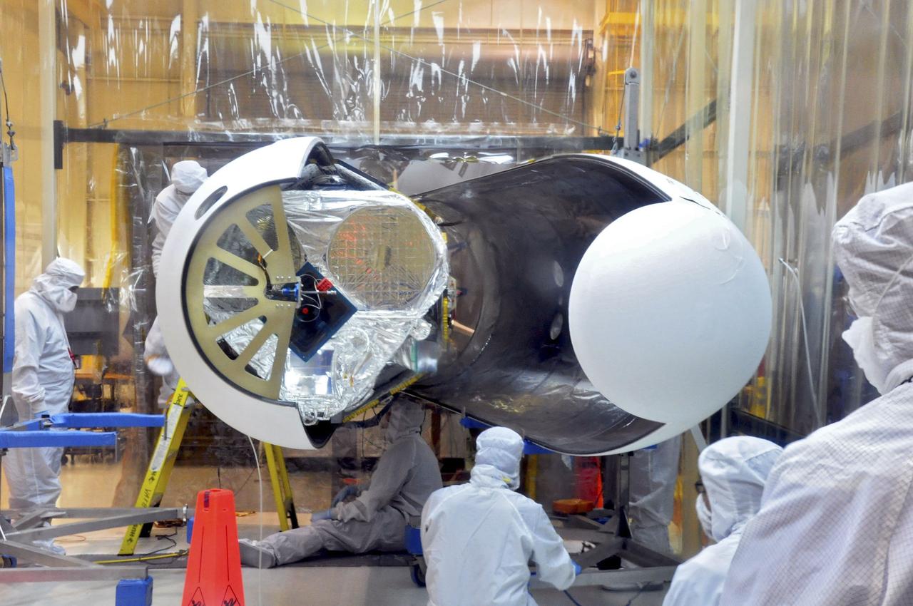 VANDENBERG AIR FORCE BASE, Calif. – Orbital Sciences technicians complete final checks of NASA's Nuclear Spectroscopic Telescope Array, or NuSTAR, inside the Orbital Sciences processing facility at Vandenberg Air Force Base in California before the Pegasus payload fairing is secured around it. NuSTAR already is mated to its Pegasus XL rocket, which is positioned behind the spacecraft outside the environmental enclosure. Encapsulation of NuSTAR in its fairing is a significant prelaunch milestone. The fairing will protect the spacecraft from the heat and aerodynamic pressure generated during ascent to orbit. After processing of the rocket and spacecraft are complete, they will be flown on Orbital's L-1011 carrier aircraft from Vandenberg to the Ronald Reagan Ballistic Missile Defense Test Site on the Pacific Ocean’s Kwajalein Atoll for launch in March. The high-energy x-ray telescope will conduct a census of black holes, map radioactive material in young supernovae remnants, and study the origins of cosmic rays and the extreme physics around collapsed stars. For more information, visit http://www.nasa.gov/nustar. Photo credit: NASA/Randy Beaudoin, VAFB