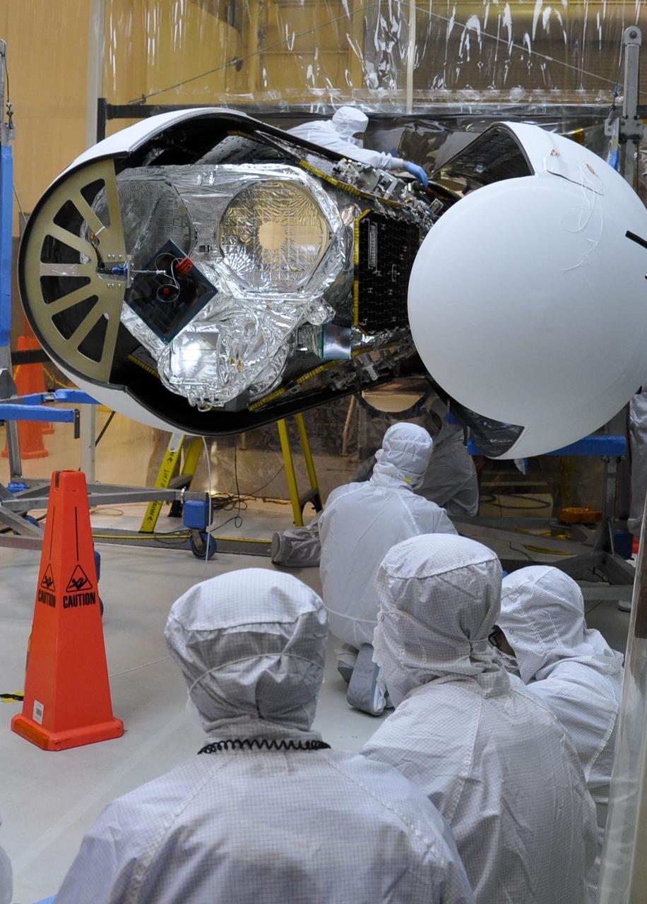 VANDENBERG AIR FORCE BASE, Calif. – An Orbital Sciences technician ensures that NASA's Nuclear Spectroscopic Telescope Array, or NuSTAR, is ready for its Pegasus payload fairing to be secured around it inside the Orbital Sciences processing facility at Vandenberg Air Force Base in California. NuSTAR already is mated to its Pegasus XL rocket, which is positioned behind the spacecraft outside the environmental enclosure. Encapsulation of NuSTAR in its fairing is a significant prelaunch milestone. The fairing will protect the spacecraft from the heat and aerodynamic pressure generated during ascent to orbit. After processing of the rocket and spacecraft are complete, they will be flown on Orbital's L-1011 carrier aircraft from Vandenberg to the Ronald Reagan Ballistic Missile Defense Test Site on the Pacific Ocean’s Kwajalein Atoll for launch in March. The high-energy x-ray telescope will conduct a census of black holes, map radioactive material in young supernovae remnants, and study the origins of cosmic rays and the extreme physics around collapsed stars. For more information, visit http://www.nasa.gov/nustar. Photo credit: NASA/Randy Beaudoin, VAFB