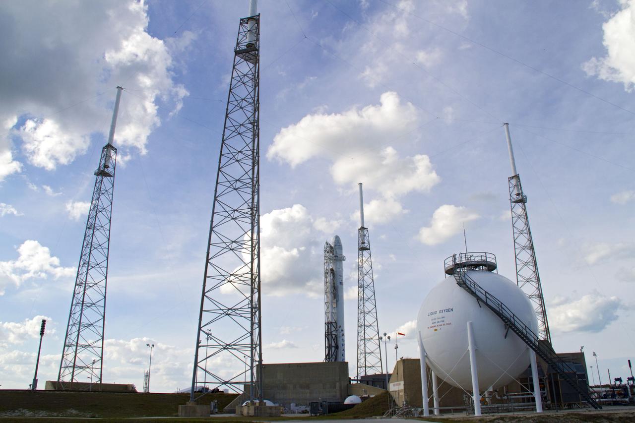 CAPE CANAVERAL, Fla. – Lightning catenary masts stand ready to protect a Falcon 9 rocket if a storm should develop over Space Launch Complex-40 on Cape Canaveral Air Force Station in Florida following a wet dress rehearsal on March 1, which included loading the rocket with its propellants and a simulated countdown. Atop the rocket is a Dragon capsule. The new rocket and capsule were designed and manufactured by Space Exploration Technologies Corp., or SpaceX, for the company’s upcoming demonstration test flight for NASA’s Commercial Orbital Transportation Services, or COTS, program. Under COTS, NASA has partnered with two private companies to develop the capability to deliver cargo to the International Space Station. During the flight, SpaceX's Dragon capsule will conduct a series of checkout procedures that will test and prove its systems. These tests include rendezvous and berthing with the space station and are intended to lead to regular resupply missions to the station. Liftoff is targeted for April 30 at 12:22 p.m. EDT pending official approval at the Flight Readiness Review on April 16. For more information, visit www.nasa.gov/exploration/commercial/cargo/spacex_index.html. Photo credit: NASA/Cory Huston