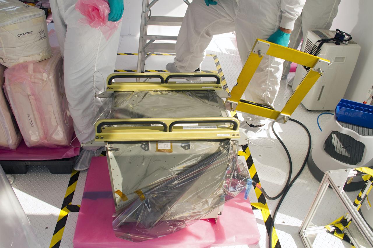 CAPE CANAVERAL, Fla. – In a processing facility at Space Launch Complex-40 on Cape Canaveral Air Force Station in Florida, preparations are under way to install cargo containers into a Dragon capsule for launch aboard a Falcon 9 rocket. The new rocket and capsule were designed and manufactured by Space Exploration Technologies Corp., or SpaceX, for the company’s upcoming demonstration test flight for NASA’s Commercial Orbital Transportation Services, or COTS, program. Under COTS, NASA has partnered with two private companies to develop the capability to deliver cargo to the International Space Station. During the flight, SpaceX's Dragon capsule will conduct a series of checkout procedures that will test and prove its systems. These tests include rendezvous and berthing with the space station and are intended to lead to regular resupply missions to the station. Liftoff is targeted for April 30 at 12:22 p.m. EDT pending official approval at the Flight Readiness Review on April 16. For more information, visit www.nasa.gov/exploration/commercial/cargo/spacex_index.html. Photo credit: NASA/Cory Huston