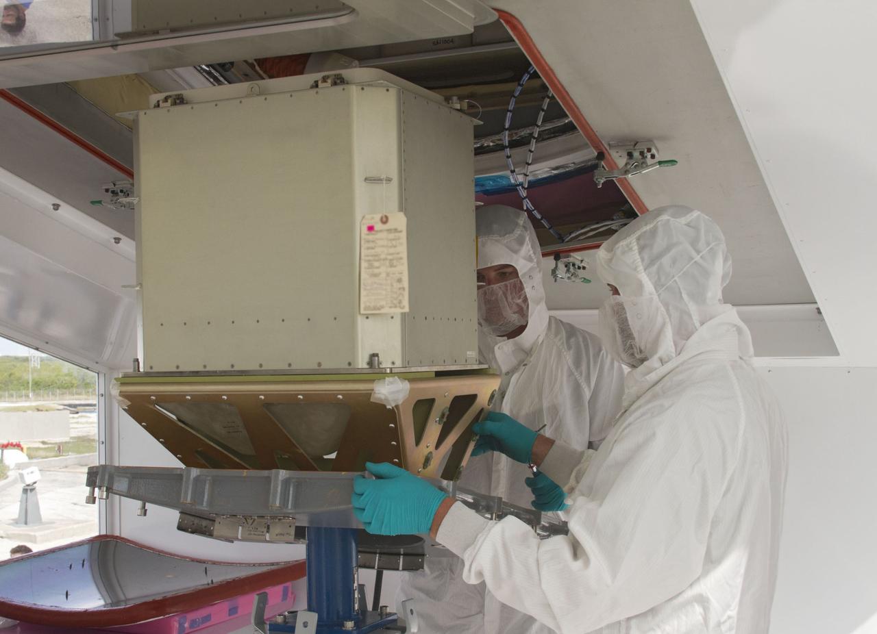 CAPE CANAVERAL, Fla. – In a processing facility at Space Launch Complex-40 on Cape Canaveral Air Force Station in Florida, aerospace technicians prepare to position a cargo container onto a lift to facilitate its installation into a Dragon capsule. The Dragon is set to launch aboard a Falcon 9 rocket. The new rocket and capsule were designed and manufactured by Space Exploration Technologies Corp., or SpaceX, for the company’s upcoming demonstration test flight for NASA’s Commercial Orbital Transportation Services, or COTS, program. Under COTS, NASA has partnered with two private companies to develop the capability to deliver cargo to the International Space Station. During the flight, SpaceX's Dragon capsule will conduct a series of checkout procedures that will test and prove its systems. These tests include rendezvous and berthing with the space station and are intended to lead to regular resupply missions to the station. Liftoff is targeted for April 30 at 12:22 p.m. EDT pending official approval at the Flight Readiness Review on April 16. For more information, visit www.nasa.gov/exploration/commercial/cargo/spacex_index.html. Photo credit: NASA/Cory Huston