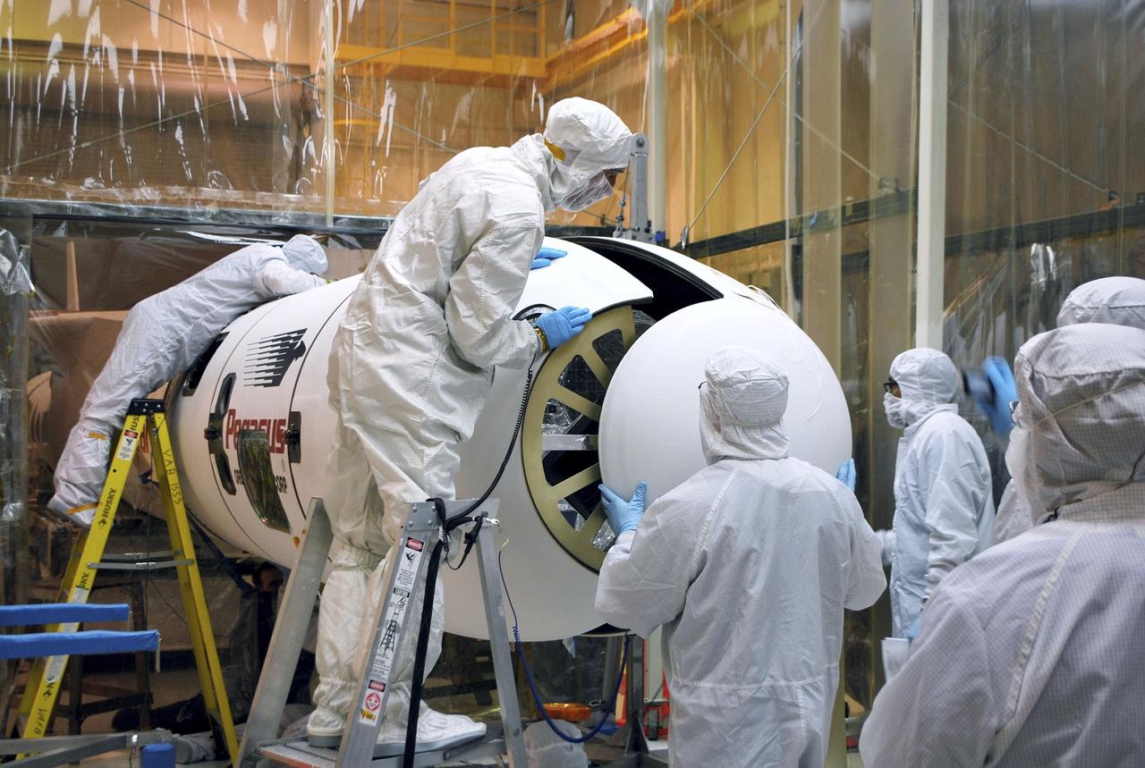 VANDENBERG AIR FORCE BASE, Calif. – Inside the Orbital Sciences processing facility at Vandenberg Air Force Base in California, Orbital’s technicians align the sections of the Pegasus payload fairing around NASA's Nuclear Spectroscopic Telescope Array, or NuSTAR. On Feb. 17, NuSTAR was mated to its Pegasus XL rocket, which is positioned behind the spacecraft outside the environmental enclosure. The fairing will protect the spacecraft from the heat and aerodynamic pressure generated during ascent to orbit. Encapsulation of NuSTAR in its fairing is a significant prelaunch milestone. After processing of the rocket and spacecraft are complete, they will be flown on Orbital's L-1011 carrier aircraft from Vandenberg to the Ronald Reagan Ballistic Missile Defense Test Site on the Pacific Ocean’s Kwajalein Atoll for launch in March. The high-energy x-ray telescope will conduct a census of black holes, map radioactive material in young supernovae remnants, and study the origins of cosmic rays and the extreme physics around collapsed stars. For more information, visit http://www.nasa.gov/nustar. Photo credit: NASA/Randy Beaudoin, VAFB