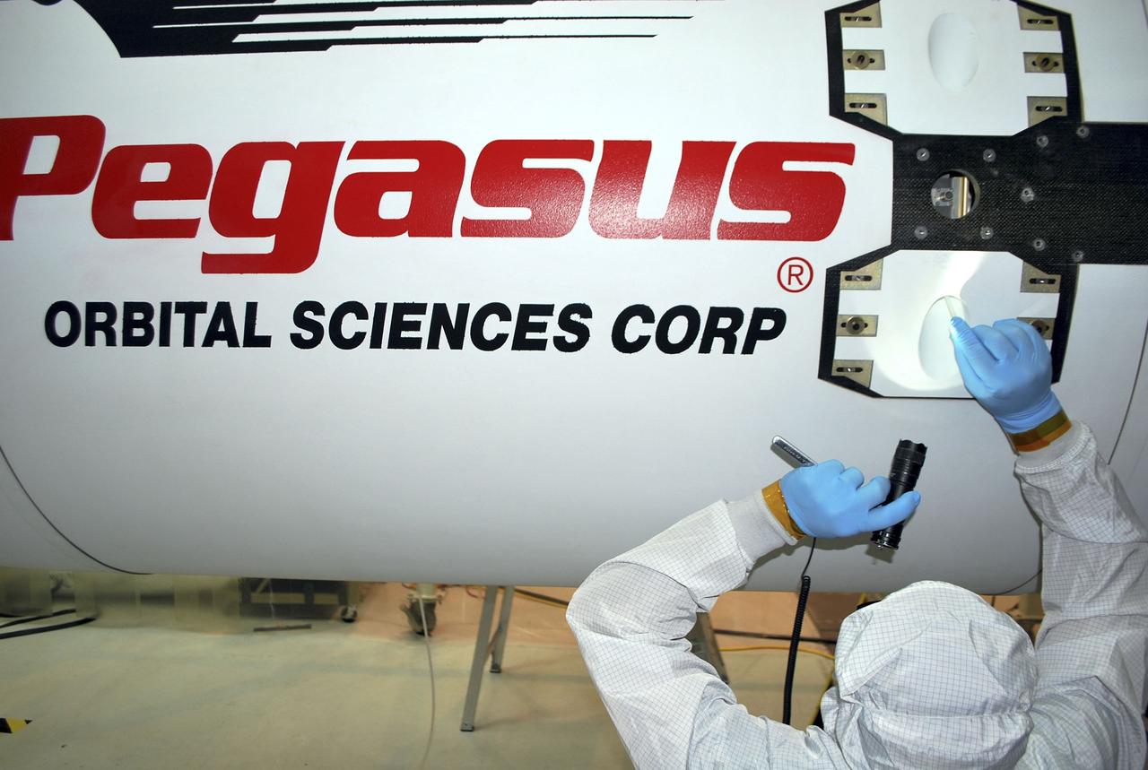 VANDENBERG AIR FORCE BASE, Calif. – Inside the Orbital Sciences processing facility at Vandenberg Air Force Base in California, an Orbital technician secures the Pegasus payload fairing around NASA's Nuclear Spectroscopic Telescope Array, or NuSTAR, completing the two-day process. On Feb. 17, NuSTAR was mated to its Pegasus XL rocket, which is positioned behind the spacecraft outside the environmental enclosure. The fairing will protect the spacecraft from the heat and aerodynamic pressure generated during ascent to orbit. Encapsulation of NuSTAR in its fairing is a significant prelaunch milestone. After processing of the rocket and spacecraft are complete, they will be flown on Orbital's L-1011 carrier aircraft from Vandenberg to the Ronald Reagan Ballistic Missile Defense Test Site on the Pacific Ocean’s Kwajalein Atoll for launch in March. The high-energy x-ray telescope will conduct a census of black holes, map radioactive material in young supernovae remnants, and study the origins of cosmic rays and the extreme physics around collapsed stars. For more information, visit http://www.nasa.gov/nustar. Photo credit: NASA/Randy Beaudoin, VAFB