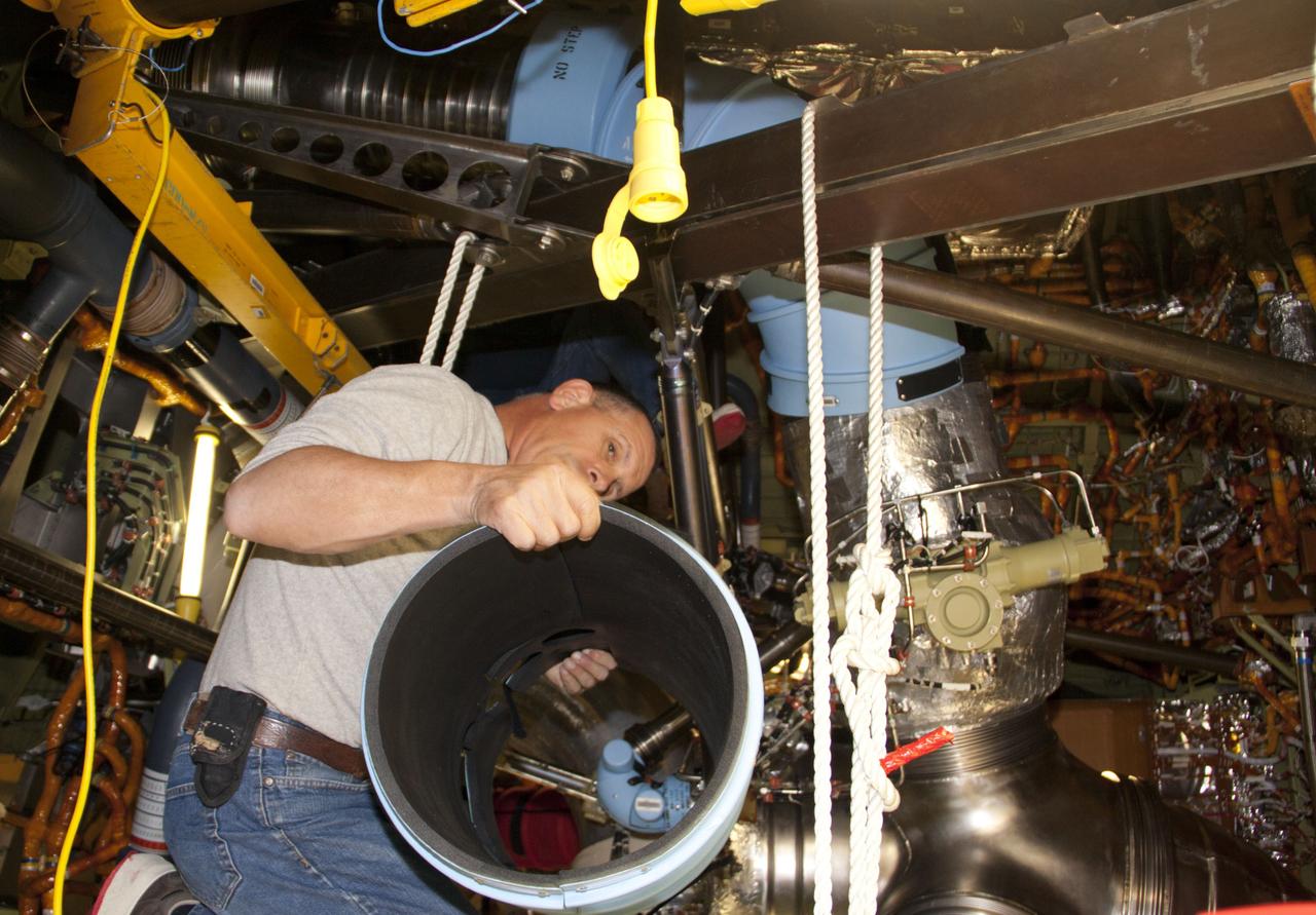 CAPE CANAVERAL, Fla. – Inside Orbiter Processing Facility-1 at NASA’s Kennedy Space Center in Florida, technicians prepare to remove space shuttle Discovery’s main propulsion system protective covers. The work is part of the Space Shuttle Program’s transition and retirement processing of shuttle Discovery, which is being prepared for display at Smithsonian’s National Air and Space Museum, Steven F. Udvar-Hazy Center in Chantilly, Va. Discovery is scheduled to be transported atop a NASA Shuttle Carrier Aircraft modified 747 jet to Dulles International Airport in Virginia on April 17 and then moved to the Smithsonian for permanent public display on April 19. For more information, visit http://www.nasa.gov/shuttle. Photo credit: NASA/Jim Grossmann