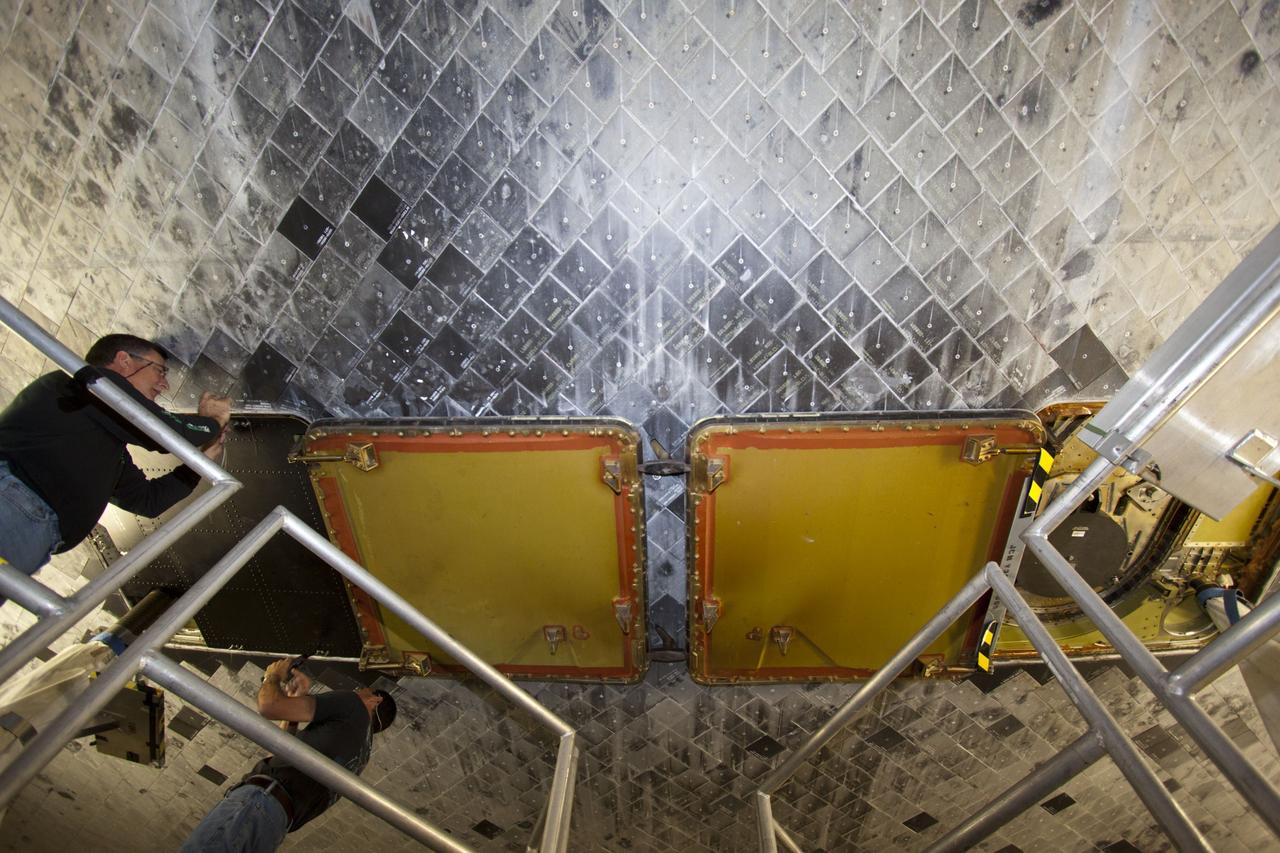 CAPE CANAVERAL, Fla. – Inside Orbiter Processing Facility-1 at NASA’s Kennedy Space Center in Florida, technicians install the ferry flight doors on space shuttle Discovery.    The work is part of the Space Shuttle Program’s transition and retirement processing of shuttle Discovery, which is being prepared for display at Smithsonian’s National Air and Space Museum, Steven F. Udvar-Hazy Center in Chantilly, Va. Discovery is scheduled to be transported atop a NASA Shuttle Carrier Aircraft modified 747 jet to Dulles International Airport in Virginia on April 17 and then moved to the Smithsonian for permanent public display on April 19. For more information, visit http://www.nasa.gov/shuttle.  Photo credit: NASA/Jim Grossmann