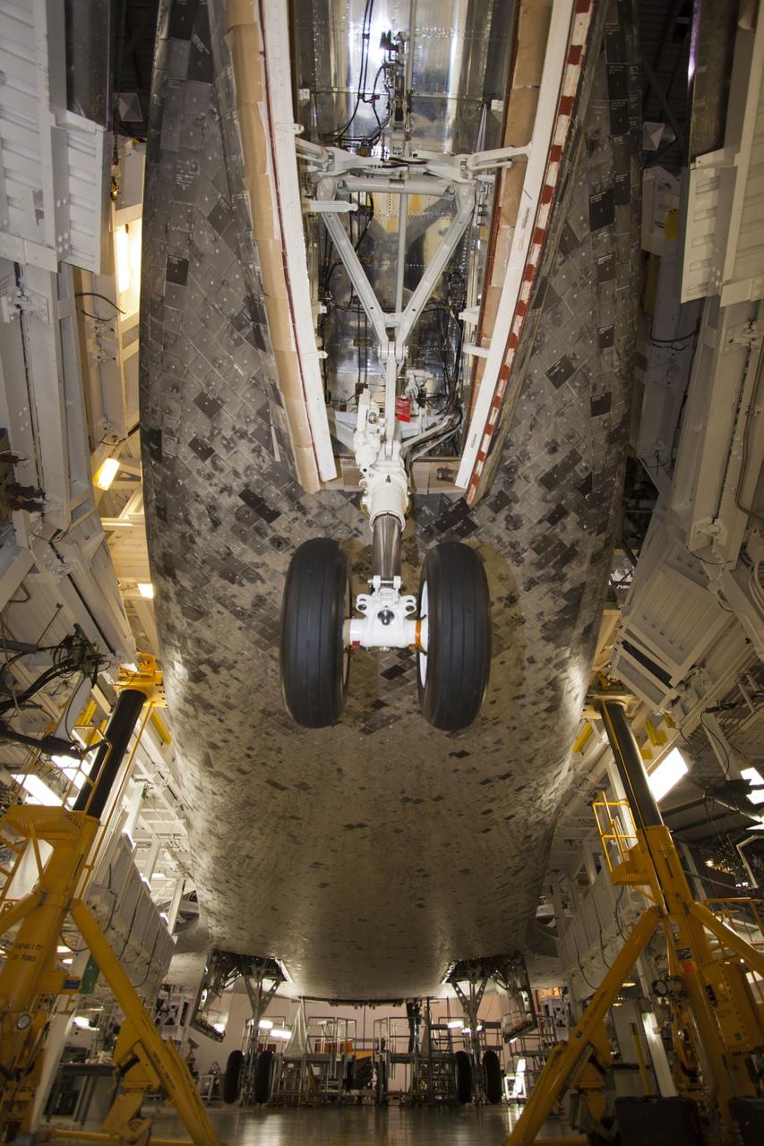CAPE CANAVERAL, Fla. – Inside Orbiter Processing Facility-1 at NASA’s Kennedy Space Center in Florida, a long-angle view reveals the underside of space shuttle Discovery where the ferry flight doors are being installed. The work is part of the Space Shuttle Program’s transition and retirement processing of shuttle Discovery, which is being prepared for display at Smithsonian’s National Air and Space Museum, Steven F. Udvar-Hazy Center in Chantilly, Va. Discovery is scheduled to be transported atop a NASA Shuttle Carrier Aircraft modified 747 jet to Dulles International Airport in Virginia on April 17 and then moved to the Smithsonian for permanent public display on April 19. For more information, visit http://www.nasa.gov/shuttle. Photo credit: NASA/Jim Grossmann