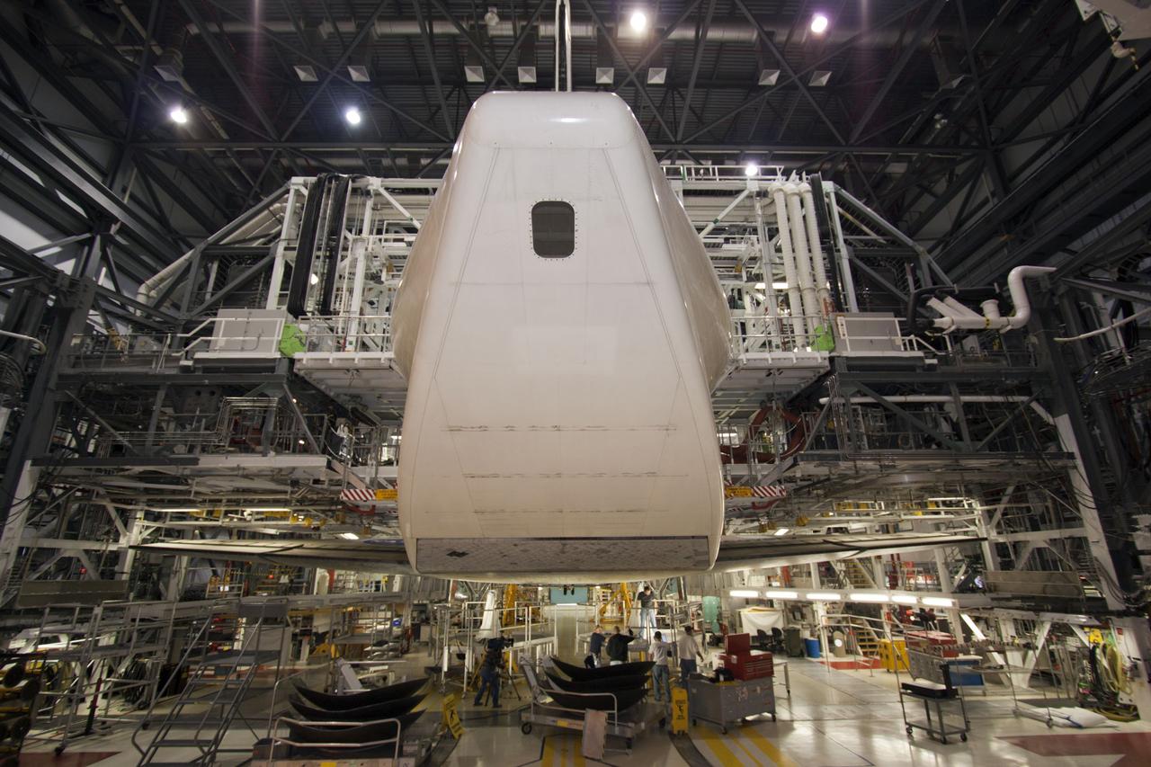 CAPE CANAVERAL, Fla. – Inside Orbiter Processing Facility-1 at NASA’s Kennedy Space Center in Florida, technicians continue work to install the ferry flight doors on space shuttle Discovery. The view shows the aft section of the shuttle with the tail cone installed over the shuttle replica engines.. The work is part of the Space Shuttle Program’s transition and retirement processing of shuttle Discovery, which is being prepared for display at Smithsonian’s National Air and Space Museum, Steven F. Udvar-Hazy Center in Chantilly, Va. Discovery is scheduled to be transported atop a NASA Shuttle Carrier Aircraft modified 747 jet to Dulles International Airport in Virginia on April 17 and then moved to the Smithsonian for permanent public display on April 19. For more information, visit http://www.nasa.gov/shuttle. Photo credit: NASA/Jim Grossmann