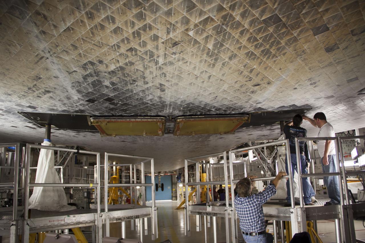 CAPE CANAVERAL, Fla. – Inside Orbiter Processing Facility-1 at NASA’s Kennedy Space Center in Florida, technicians complete the work to install the ferry flight doors on space shuttle Discovery. The work is part of the Space Shuttle Program’s transition and retirement processing of shuttle Discovery, which is being prepared for display at Smithsonian’s National Air and Space Museum, Steven F. Udvar-Hazy Center in Chantilly, Va. Discovery is scheduled to be transported atop a NASA Shuttle Carrier Aircraft modified 747 jet to Dulles International Airport in Virginia on April 17 and then moved to the Smithsonian for permanent public display on April 19. For more information, visit http://www.nasa.gov/shuttle. Photo credit: NASA/Jim Grossmann