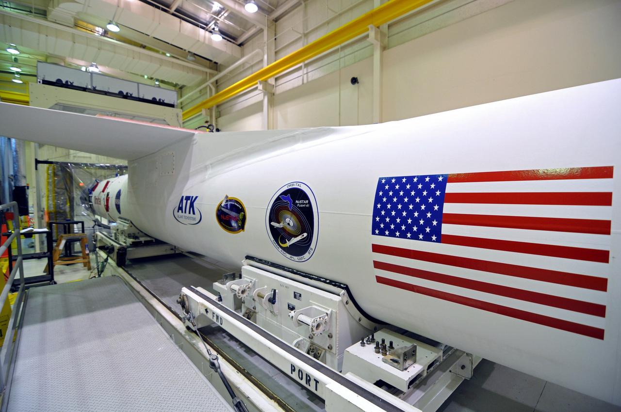 VANDENBERG AIR FORCE BASE, Calif. – Inside the Orbital Sciences processing facility at Vandenberg Air Force Base in California, NASA's Nuclear Spectroscopic Telescope Array, or NuSTAR, awaits launch. The spacecraft has been mated with its Pegasus XL rocket and enclosed in the Pegasus payload fairing on the forward end of the rocket, at left.    The fairing will protect the spacecraft from the heat and aerodynamic pressure generated during the rocket’s ascent to orbit.  After processing of the rocket and spacecraft are complete, they will be flown on Orbital's L-1011 carrier aircraft from Vandenberg to the Ronald Reagan Ballistic Missile Defense Test Site on the Pacific Ocean’s Kwajalein Atoll for launch in March. The high-energy X-ray telescope will conduct a census of black holes, map radioactive material in young supernovae remnants, and study the origins of cosmic rays and the extreme physics around collapsed stars. For more information, visit http://www.nasa.gov/nustar.  Photo credit: NASA/Randy Beaudoin, VAFB