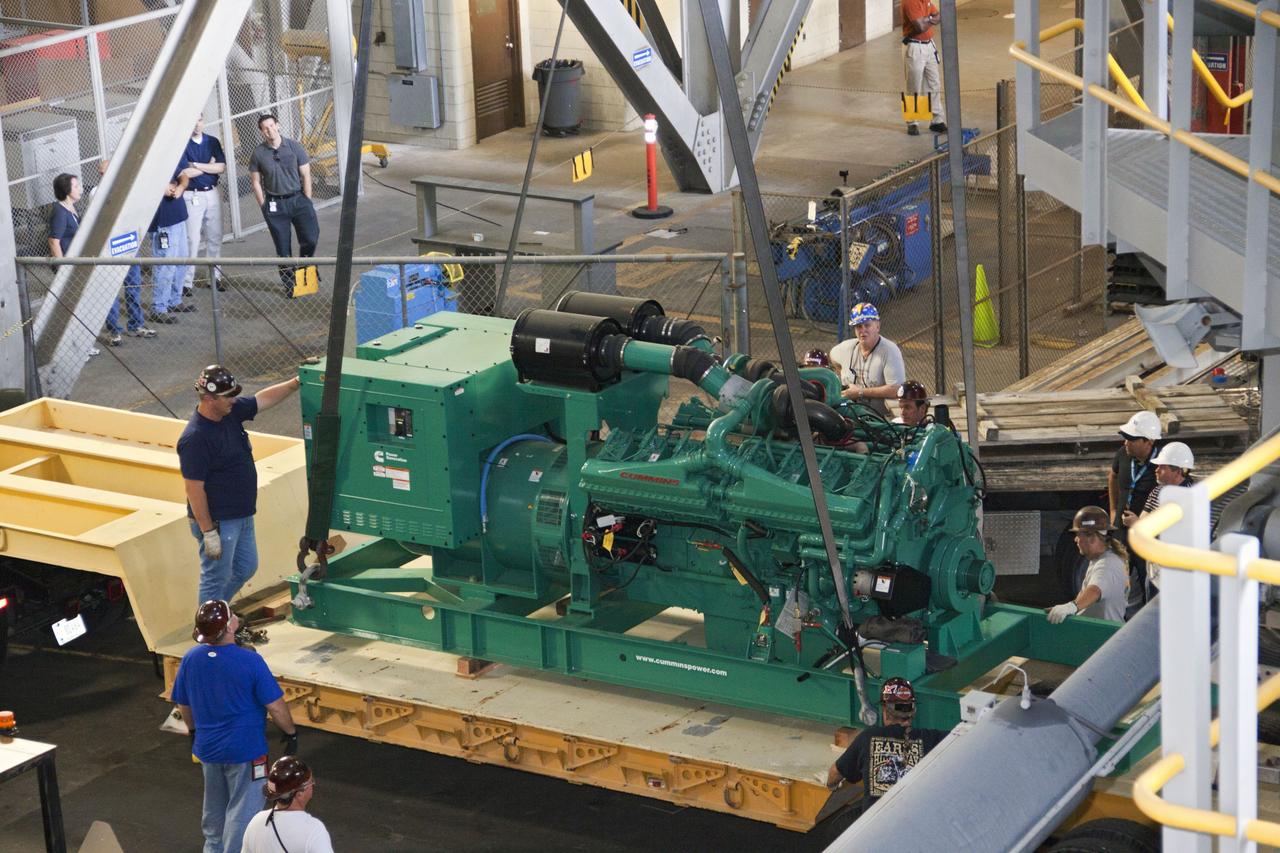 CAPE CANAVERAL, Fla. – Inside the Vehicle Assembly Building at NASA’s Kennedy Space Center in Florida, technicians prepare a new engine and generator for installation on crawler-transporter 2 CT-2). The Apollo era diesel engines were removed last month. Work continues in high bay 2 to upgrade CT-2 so that it can carry NASA’s Space Launch System heavy-lift rocket, which is under design, and new Orion spacecraft to the launch pad. The crawler-transporters were used to carry the mobile launcher platform and space shuttle to Launch Complex 39 for space shuttle launches for 30 years. Photo credit: NASA/Jim Grossmann