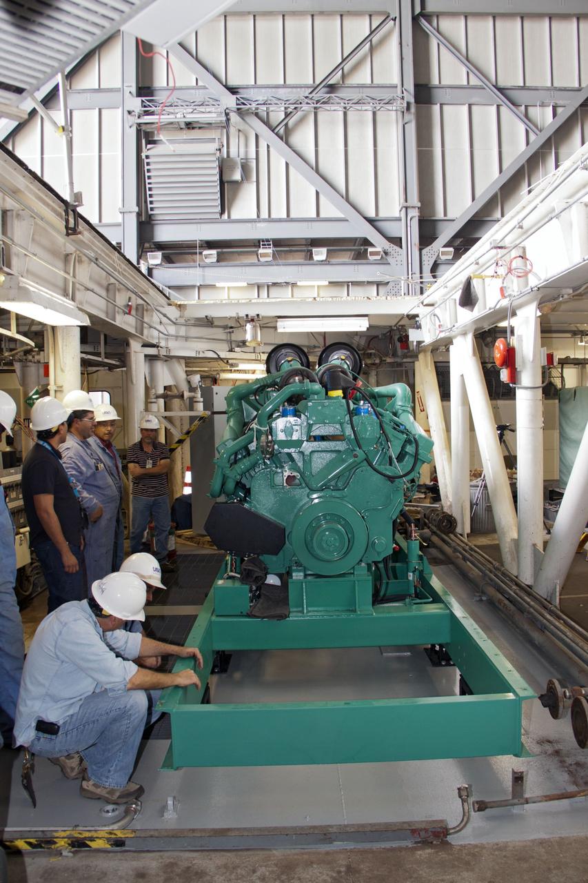 CAPE CANAVERAL, Fla. – Inside the Vehicle Assembly Building at NASA’s Kennedy Space Center in Florida, technicians begin the work to secure a new engine and generator inside crawler-transporter 2 CT-2). The Apollo era diesel engines were removed last month. Work continues in high bay 2 to upgrade CT-2 so that it can carry NASA’s Space Launch System heavy-lift rocket, which is under design, and new Orion spacecraft to the launch pad. The crawler-transporters were used to carry the mobile launcher platform and space shuttle to Launch Complex 39 for space shuttle launches for 30 years. Photo credit: NASA/Jim Grossmann
