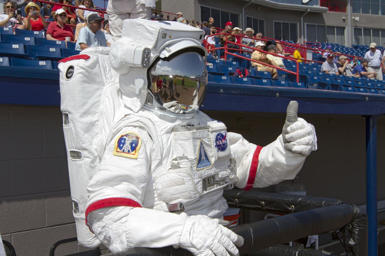 VIERA, Fla. – NASA Kennedy Space Center’s “Spaceperson” signals that “all systems are go” for Space Day at the Space Coast Stadium. Bob Cabana, director of Kennedy, is on hand to throw the first pitch of a spring training game between Major League Baseball's Washington Nationals and the Houston Astros. Kennedy also set up a booth at the stadium for the occasion to highlight some of the contributions the space agency has made to sports, transportation and everyday life. A full-scale test version of NASA's new Orion Multi-Purpose Crew Vehicle was on display outside the stadium to show the public the spacecraft under development that will take astronauts farther into space than ever before. For more information, visit http://www.nasa.gov/kennedy. Photo credit: NASA/Kim Shiflett