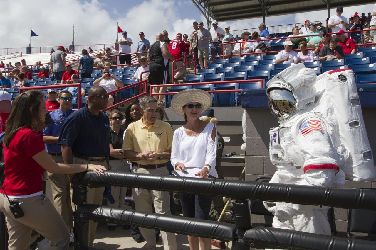 VIERA, Fla. – NASA Kennedy Space Center’s “Spaceperson” hangs out with baseball fans at the Space Coast Stadium’s Space Day. From left are Shannon Comerford, spring training coordinator for the Washington Nationals, Kelvin Manning, Kennedy associate director, Bob Cabana, Kennedy director, and Gretchen Dimmer, budget analyst in Kennedy’s Office of the Chief Financial Officer.  Cabana was on hand to throw the first pitch of the spring training game between Major League Baseball's Washington Nationals and Houston Astros. Kennedy also set up a booth at the stadium for the occasion to highlight some of the contributions the space agency has made to sports, transportation and everyday life.  A full-scale test version of NASA's new Orion Multi-Purpose Crew Vehicle was on display outside the stadium to show the public the spacecraft under development that will take astronauts farther into space than ever before.    For more information, visit http://www.nasa.gov/kennedy.  Photo credit: NASA/Kim Shiflett