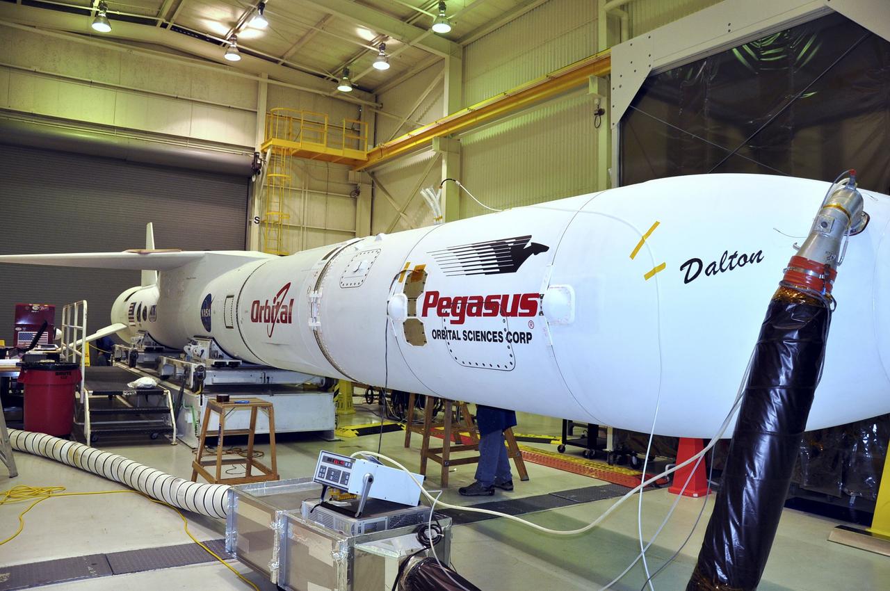 VANDENBERG AIR FORCE BASE, Calif. – Inside the Orbital Sciences processing facility at Vandenberg Air Force Base in California, NASA's Nuclear Spectroscopic Telescope Array, or NuSTAR, awaits rollout for mating to the L-1011 Orbital carrier aircraft. Previously, the spacecraft was mated with its Pegasus XL rocket and enclosed in the Pegasus payload fairing. Cool, dry air is being pumped into the fairing through a purge line to maintain the proper environment for the spacecraft in the confined space. The fairing will protect the spacecraft from the heat and aerodynamic pressure generated during the rocket’s ascent to orbit. After processing of the rocket and spacecraft are complete, they will be flown on Orbital's L-1011 carrier aircraft from Vandenberg to the Ronald Reagan Ballistic Missile Defense Test Site on the Pacific Ocean’s Kwajalein Atoll for launch in March. The high-energy x-ray telescope will conduct a census of black holes, map radioactive material in young supernovae remnants, and study the origins of cosmic rays and the extreme physics around collapsed stars. For more information, visit http://www.nasa.gov/nustar. Photo credit: NASA/Randy Beaudoin, VAFB