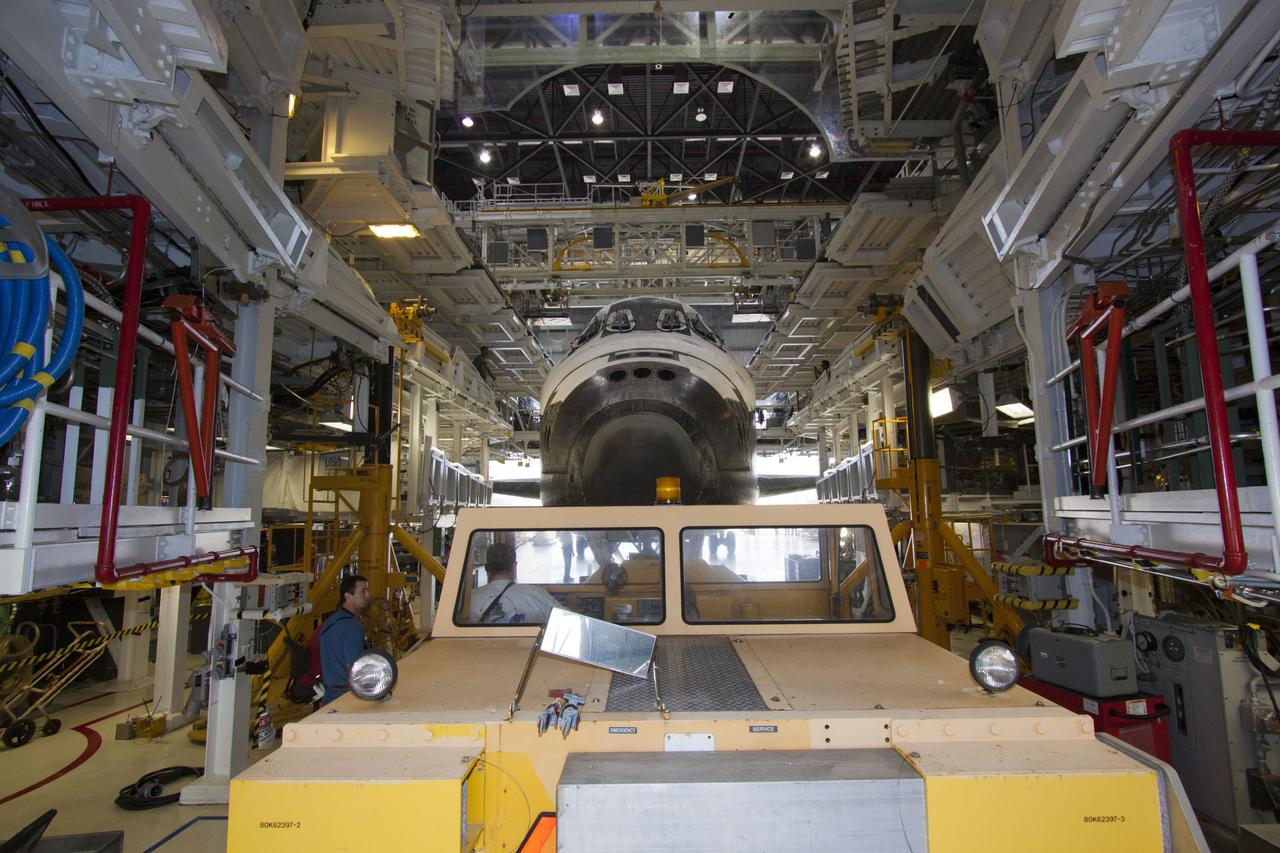 CAPE CANAVERAL, Fla. – At NASA’s Kennedy Space Center in Florida, a tow vehicle is used to back space shuttle Discovery out of Orbiter Processing Facility-1 for its move to the Vehicle Assembly Building VAB. The work is part of the Space Shuttle Program’s transition and retirement processing of shuttle Discovery, which is being prepared for display at Smithsonian’s National Air and Space Museum, Steven F. Udvar-Hazy Center in Chantilly, Va. Discovery will remain in high bay 4 of the VAB until its scheduled transport atop a NASA Shuttle Carrier Aircraft modified 747 jet to Dulles International Airport in Virginia on April 17. Discovery will then be transported to the Smithsonian on April 19. For more information, visit http://www.nasa.gov/shuttle. Photo credit: NASA/Jim Grossmann