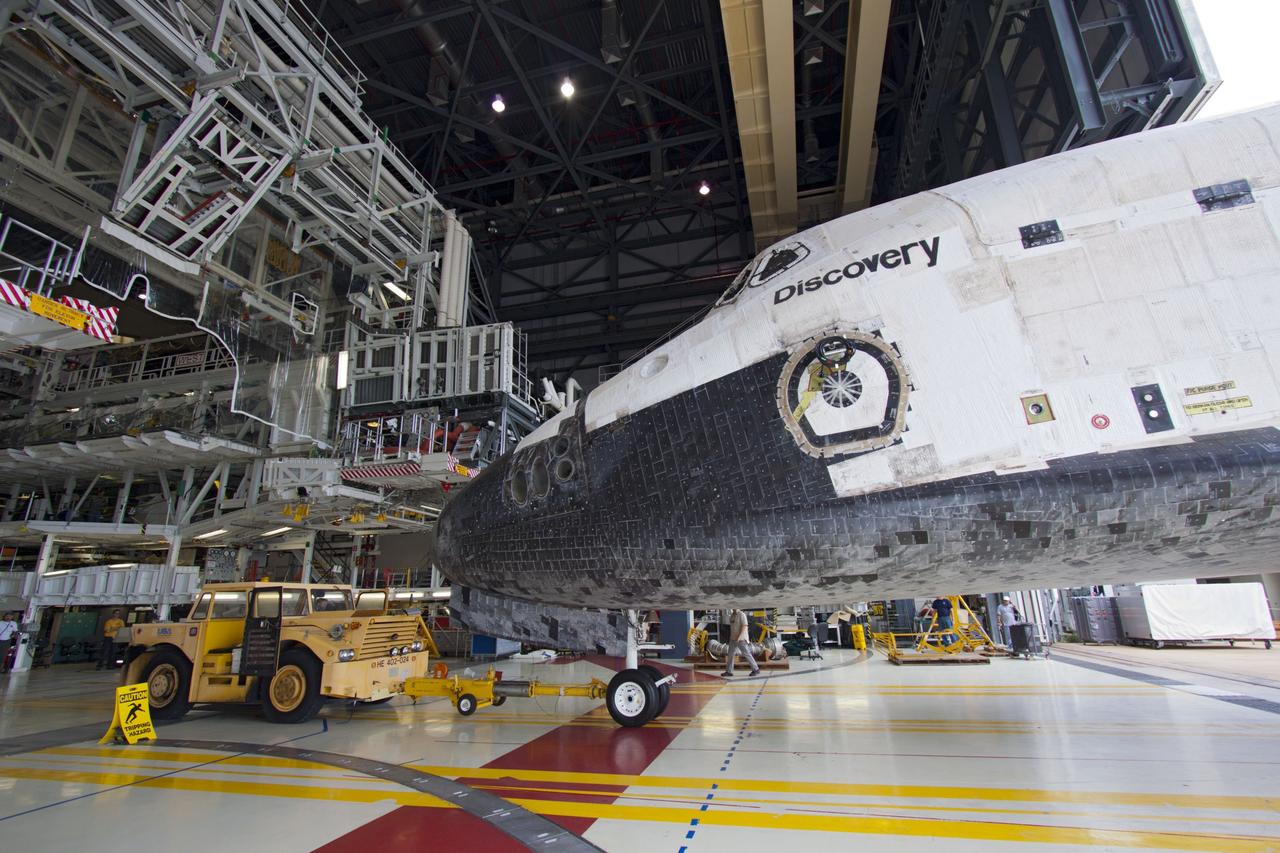 CAPE CANAVERAL, Fla. – Inside Orbiter Processing Facility-1 at NASA’s Kennedy Space Center in Florida, a tow vehicle is used to back space shuttle Discovery out of Orbiter Processing Facility-1 for its move to the Vehicle Assembly Building VAB.    The work is part of the Space Shuttle Program’s transition and retirement processing of shuttle Discovery, which is being prepared for display at Smithsonian’s National Air and Space Museum, Steven F. Udvar-Hazy Center in Chantilly, Va. Discovery will remain in high bay 4 of the VAB until its scheduled transport atop a NASA Shuttle Carrier Aircraft modified 747 jet to Dulles International Airport in Virginia on April 17. Discovery will then be transported to the Smithsonian on April 19. For more information, visit http://www.nasa.gov/shuttle.  Photo credit: NASA/Jim Grossmann
