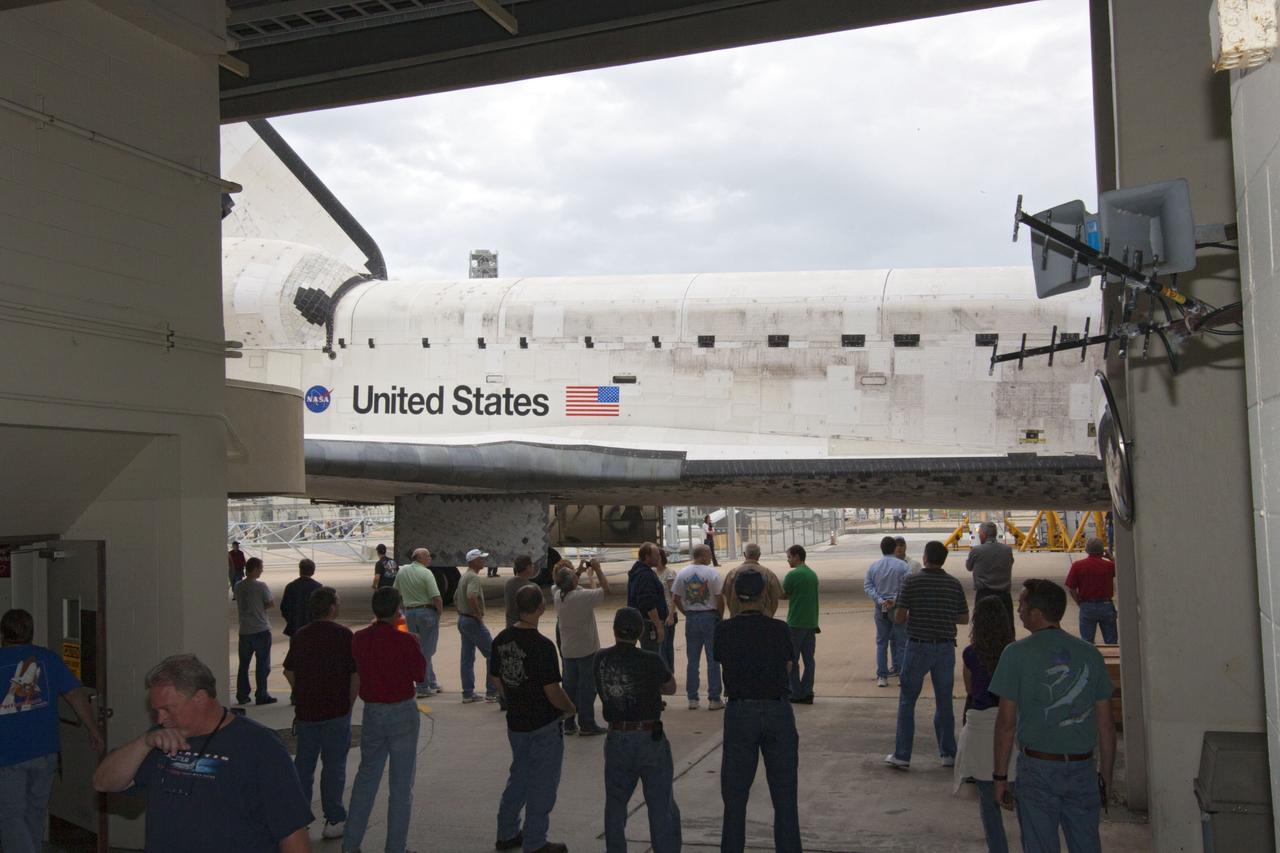 CAPE CANAVERAL, Fla. – At NASA’s Kennedy Space Center in Florida, workers watch as space shuttle Discovery is backed out of Orbiter Processing Facility-1 for its move to the Vehicle Assembly Building VAB. The work is part of the Space Shuttle Program’s transition and retirement processing of shuttle Discovery, which is being prepared for display at Smithsonian’s National Air and Space Museum, Steven F. Udvar-Hazy Center in Chantilly, Va. Discovery will remain in high bay 4 of the VAB until its scheduled transport atop a NASA Shuttle Carrier Aircraft modified 747 jet to Dulles International Airport in Virginia on April 17. Discovery will then be transported to the Smithsonian on April 19. For more information, visit http://www.nasa.gov/shuttle. Photo credit: NASA/Jim Grossmann