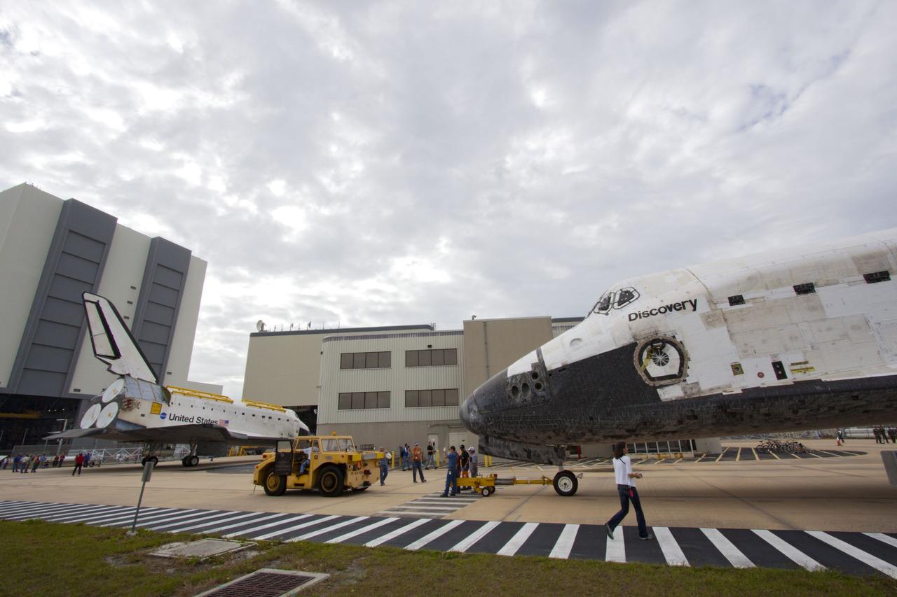 CAPE CANAVERAL, Fla. – At NASA’s Kennedy Space Center in Florida, space shuttle Discovery foreground was backed out of Orbiter Processing Facility-1 OPF-1 for its move to the Vehicle Assembly Building VAB. Meanwhile, space shuttle Atlantis is on the move to OPF-1 after being towed out of the VAB.     The work is part of the Space Shuttle Program’s transition and retirement processing of shuttle Discovery, which is being prepared for display at Smithsonian’s National Air and Space Museum, Steven F. Udvar-Hazy Center in Chantilly, Va. Discovery will remain in high bay 4 of the VAB until its scheduled transport atop a NASA Shuttle Carrier Aircraft modified 747 jet to Dulles International Airport in Virginia on April 17. Discovery will then be transported to the Smithsonian on April 19. For more information, visit http://www.nasa.gov/shuttle.  Photo credit: NASA/Jim Grossmann