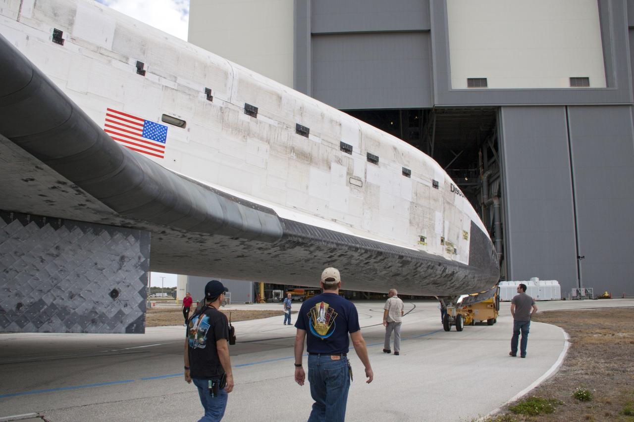 CAPE CANAVERAL, Fla. – Workers walk alongside space shuttle Discovery as it is towed to the Vehicle Assembly Building VAB from Orbiter Processing Facility-1 at NASA’s Kennedy Space Center in Florida. The work is part of the Space Shuttle Program’s transition and retirement processing of shuttle Discovery, which is being prepared for display at Smithsonian’s National Air and Space Museum, Steven F. Udvar-Hazy Center in Chantilly, Va. Discovery will remain in high bay 4 of the VAB until its scheduled transport atop a NASA Shuttle Carrier Aircraft modified 747 jet to Dulles International Airport in Virginia on April 17. Discovery will then be transported to the Smithsonian on April 19. For more information, visit http://www.nasa.gov/shuttle. Photo credit: NASA/Jim Grossmann