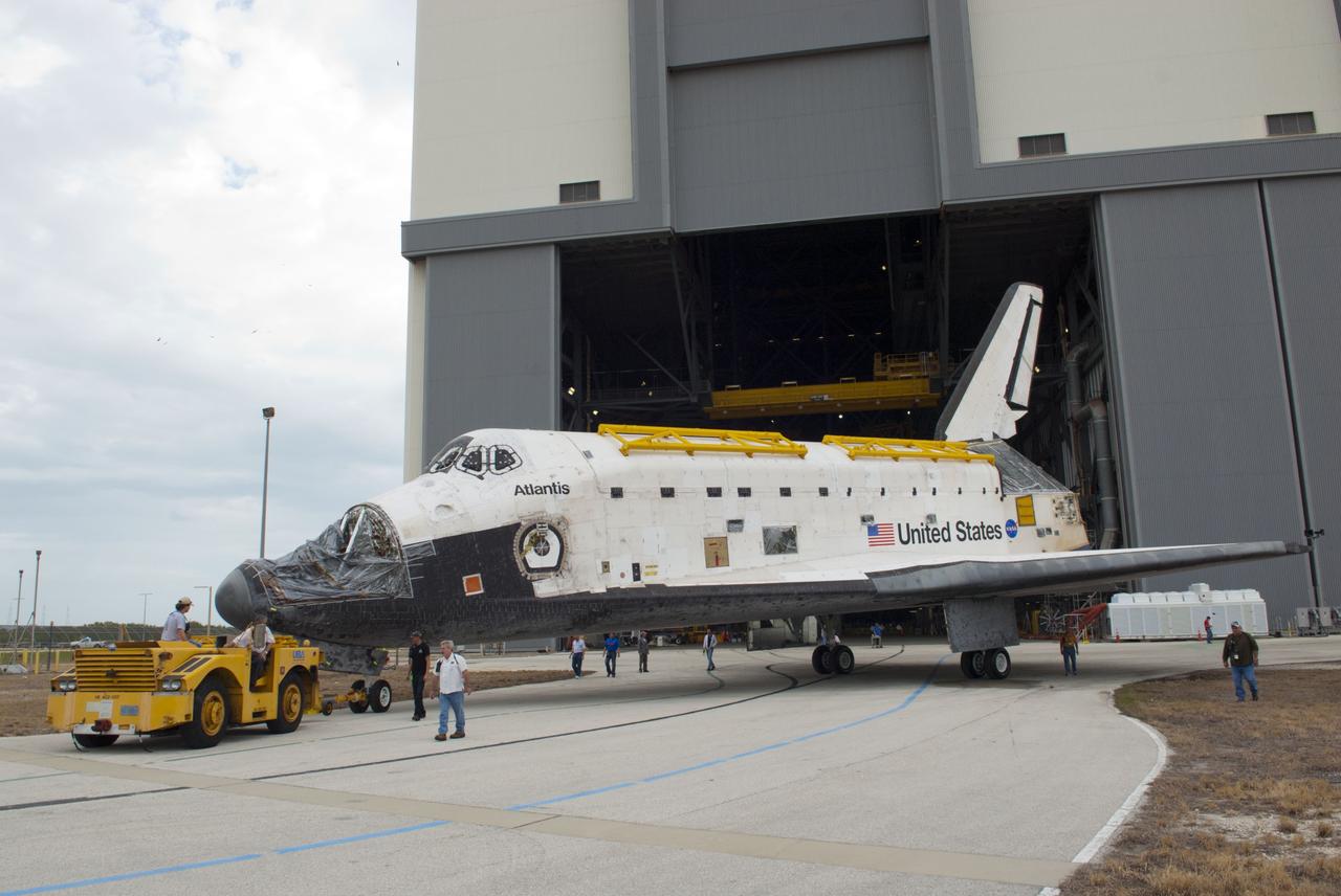 CAPE CANAVERAL, Fla. – At NASA’s Kennedy Space Center in Florida, workers walk alongside as space shuttle Atlantis is towed out of the Vehicle Assembly Building and over to Orbiter Processing Facility-1. Atlantis’ forward reaction control system, orbiter maneuvering system pods and three space shuttle main engines have been removed. The work is part of the Space Shuttle Program’s transition and retirement processing of the three space shuttles. Atlantis is being prepared for display at the Kennedy Space Center Visitor Complex and is scheduled to rollover to the complex in November. Photo credit: NASA/Tim Jacobs