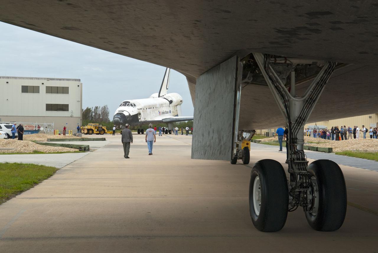 CAPE CANAVERAL, Fla. – At NASA’s Kennedy Space Center in Florida, space shuttle Atlantis is towed from the Vehicle Assembly Building toward Orbiter Processing Facility-1 OPF-1. In the background, space shuttle Discovery faces Atlantis after it was completely towed out from OPF-1. The work is part of the Space Shuttle Program’s transition and retirement processing of the three space shuttles. Atlantis is being prepared for display at the Kennedy Space Center Visitor Complex and is scheduled to rollover to the complex in November. Photo credit: NASA/Tim Jacobs
