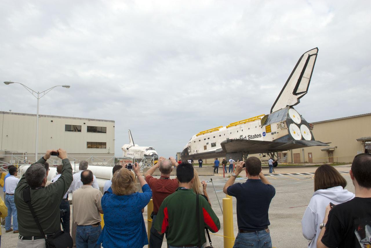 CAPE CANAVERAL, Fla. – At NASA’s Kennedy Space Center in Florida, photographers and workers snap pictures as space shuttle Atlantis is towed from the Vehicle Assembly Building toward Orbiter Processing Facility-1 OPF-1. Facing Atlantis is space shuttle Discovery after it was completely towed out from OPF-1. The work is part of the Space Shuttle Program’s transition and retirement processing of the three space shuttles. Atlantis is being prepared for display at the Kennedy Space Center Visitor Complex and is scheduled to rollover to the complex in November. Photo credit: NASA/Tim Jacobs