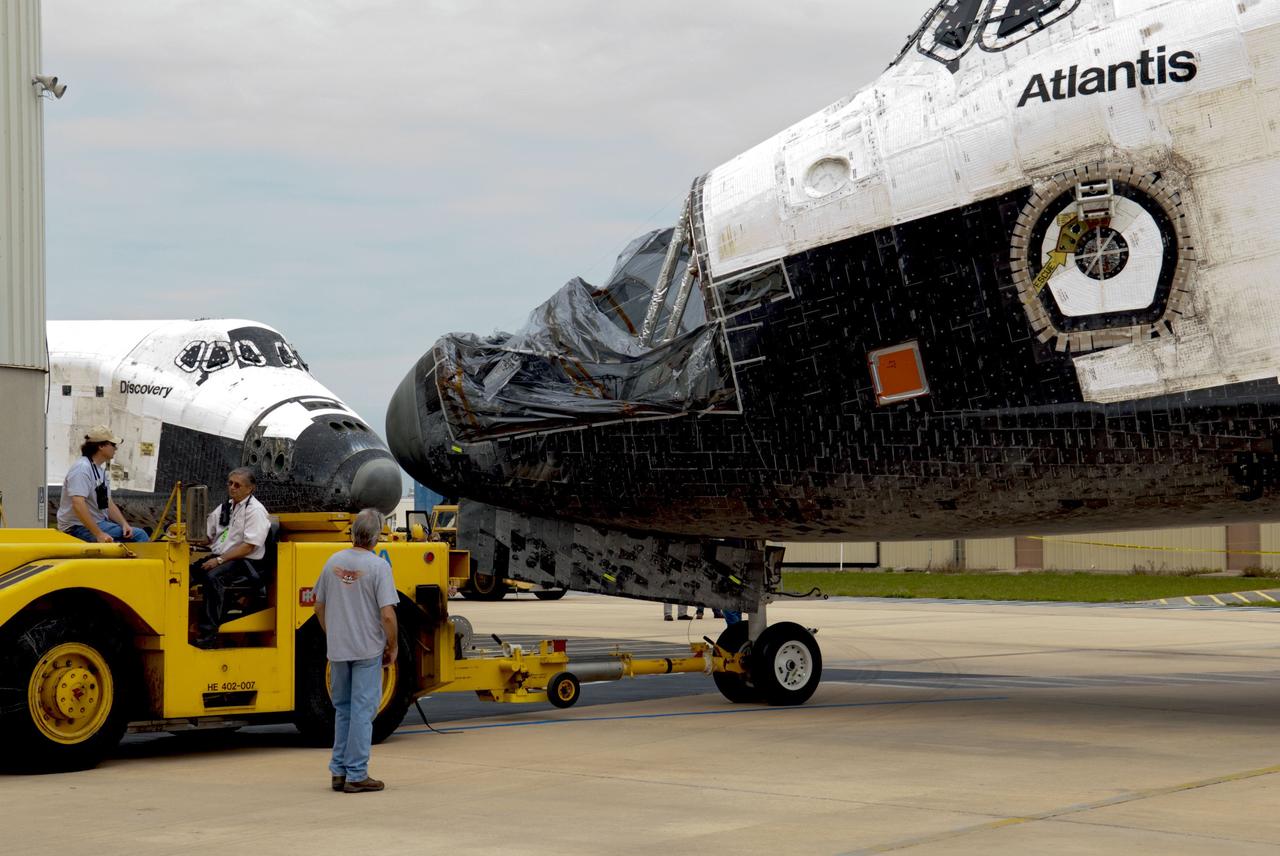 CAPE CANAVERAL, Fla. – At NASA’s Kennedy Space Center in Florida, space shuttles Atlantis foreground and Discovery appear to be nose to nose. Atlantis was towed from the Vehicle Assembly Building VAB and is being towed to Orbiter Processing Facility-1 OPF-1. Discovery was towed out of OPF-1 for its trip to the VAB. The work is part of the Space Shuttle Program’s transition and retirement processing of the three space shuttles. Atlantis is being prepared for display at the Kennedy Space Center Visitor Complex and is scheduled to rollover to the complex in November. Photo credit: NASA/Tim Jacobs