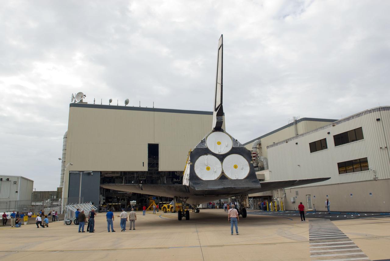 CAPE CANAVERAL, Fla. – At NASA’s Kennedy Space Center in Florida, workers monitor the progress as space shuttle Atlantis is towed toward Orbiter Processing Facility-1 after being towed from the Vehicle Assembly Building. The work is part of the Space Shuttle Program’s transition and retirement processing of the three space shuttles. Atlantis is being prepared for display at the Kennedy Space Center Visitor Complex and is scheduled to rollover to the complex in November. Photo credit: NASA/Tim Jacobs