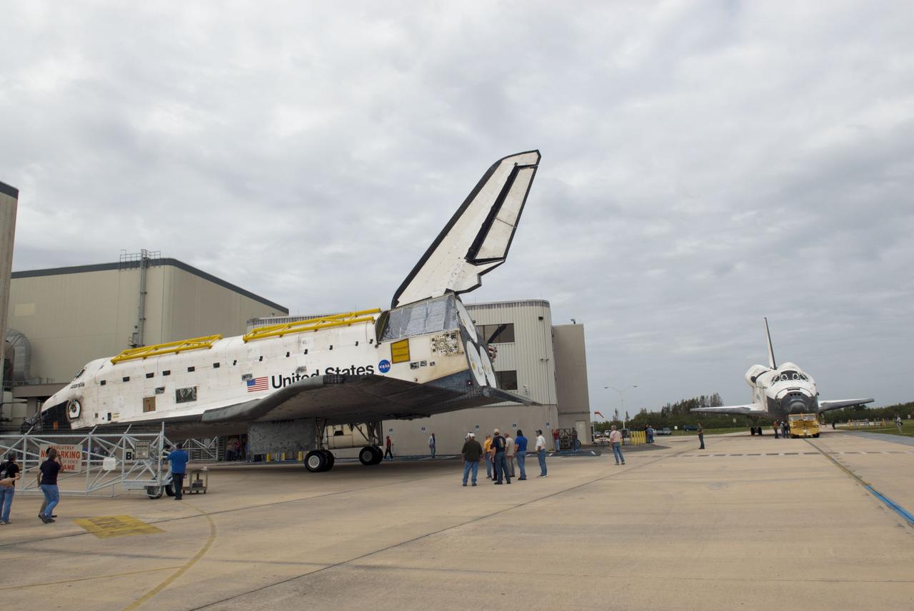 CAPE CANAVERAL, Fla. – At NASA’s Kennedy Space Center in Florida, space shuttle Atlantis is towed toward Orbiter Processing Facility-1 OPF-1 after being towed from the Vehicle Assembly Building VAB. In the background, space shuttle Discovery waits for its move to the VAB after being towed out of OPF-1. The work is part of the Space Shuttle Program’s transition and retirement processing of the three space shuttles. Atlantis is being prepared for display at the Kennedy Space Center Visitor Complex and is scheduled to rollover to the complex in November. Photo credit: NASA/Tim Jacobs