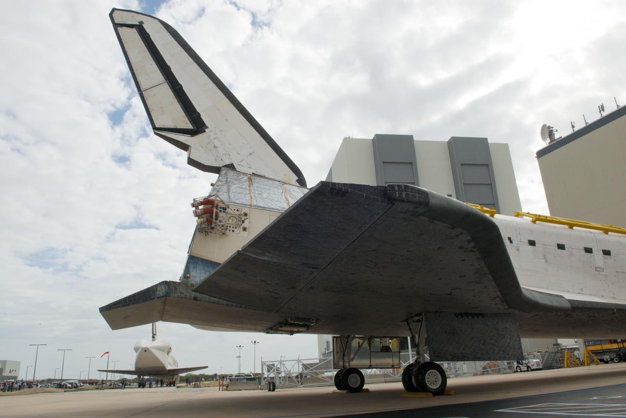 CAPE CANAVERAL, Fla. – At NASA’s Kennedy Space Center in Florida, space shuttle Atlantis has been towed to the doors of Orbiter Processing Facility-1 OPF-1 after being towed from the Vehicle Assembly Building VAB. At left, space shuttle Discovery is being towed to the VAB after being towed out of OPF-1. The tail cone protects Discovery’s three replica shuttle main engines. The work is part of the Space Shuttle Program’s transition and retirement processing of the three space shuttles. Atlantis is being prepared for display at the Kennedy Space Center Visitor Complex and is scheduled to rollover to the complex in November. Photo credit: NASA/Tim Jacobs
