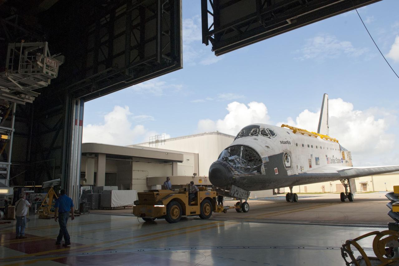 CAPE CANAVERAL, Fla. – At NASA’s Kennedy Space Center in Florida, space shuttle Atlantis is towed inside Orbiter Processing Facility-1 after being towed earlier in the day from the Vehicle Assembly Building. The work is part of the Space Shuttle Program’s transition and retirement processing of the three space shuttles. Atlantis is being prepared for display at the Kennedy Space Center Visitor Complex and is scheduled to rollover to the complex in November. Photo credit: NASA/Tim Jacobs
