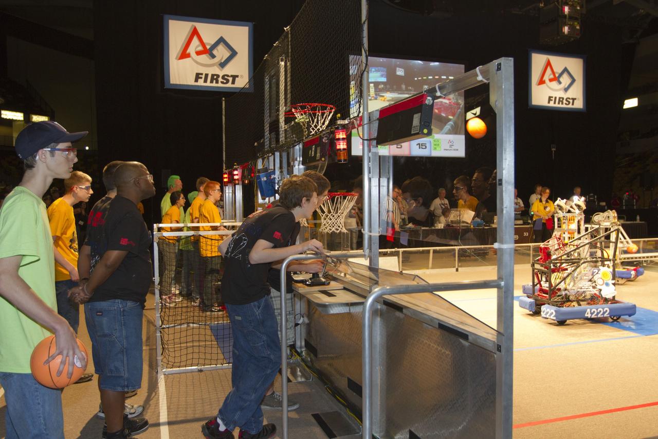 ORLANDO, Fla. -- High school teams compete in the regional FIRST robotics competition at the University of Central Florida in Orlando, Fla. More than 60 teams took part in the competition called "For Inspiration and Recognition of Science and Technology," or FIRST, in hopes of advancing to the national robotics championship. This year, the competition resembled a basketball game and was dubbed "Rebound Rumble." The game measured the effectiveness of each robot, the power of collaboration and the determination of the teams.    FIRST, founded in 1989, is a non-profit organization that designs accessible, innovative programs to build self-confidence, knowledge and life skills while motivating young people to pursue academic opportunities. The robotics competition challenges teams of high school students and their mentors to solve a common problem in a six-week timeframe using a standard kit of parts and a common set of rules. NASA is the largest sponsor of the international program. Kennedy Space Center is a sponsor of the regional event. For more information on Kennedy's education events and initiatives, go to http://www.nasa.gov/offices/education/centers/kennedy/home/index.html. Photo credit: NASA/Kim Shiflett