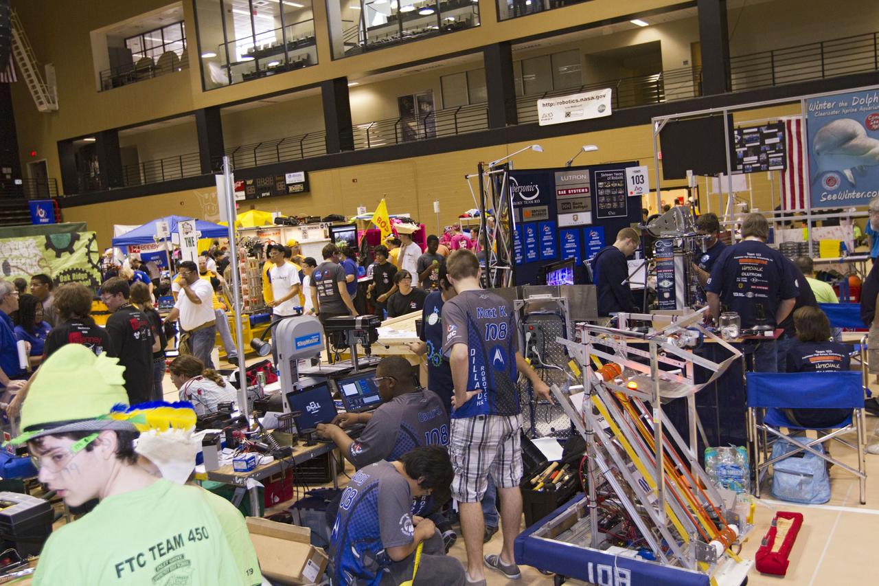 ORLANDO, Fla. -- High school teams tinker with their robots during the regional FIRST robotics competition at the University of Central Florida in Orlando, Fla. More than 60 teams took part in the competition called "For Inspiration and Recognition of Science and Technology," or FIRST, in hopes of advancing to the national robotics championship. This year ,the competition resembled a basketball game and was dubbed "Rebound Rumble." The game measured the effectiveness of each robot, the power of collaboration and the determination of the teams.    FIRST, founded in 1989, is a non-profit organization that designs accessible, innovative programs to build self-confidence, knowledge and life skills while motivating young people to pursue academic opportunities. The robotics competition challenges teams of high school students and their mentors to solve a common problem in a six-week timeframe using a standard kit of parts and a common set of rules. NASA is the largest sponsor of the international program. Kennedy Space Center is a sponsor of the regional event. For more information on Kennedy's education events and initiatives, go to http://www.nasa.gov/offices/education/centers/kennedy/home/index.html. Photo credit: NASA/Kim Shiflett