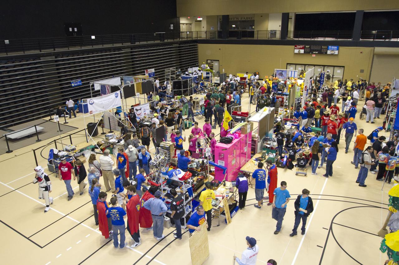 ORLANDO, Fla. -- High school teams tinker with their robots during the regional FIRST robotics competition at the University of Central Florida in Orlando, Fla. More than 60 teams took part in the competition called "For Inspiration and Recognition of Science and Technology," or FIRST, in hopes of advancing to the national robotics championship. This year, the competition resembled a basketball game and was dubbed "Rebound Rumble." The game measured the effectiveness of each robot, the power of collaboration and the determination of the teams.    FIRST, founded in 1989, is a non-profit organization that designs accessible, innovative programs to build self-confidence, knowledge and life skills while motivating young people to pursue academic opportunities. The robotics competition challenges teams of high school students and their mentors to solve a common problem in a six-week timeframe using a standard kit of parts and a common set of rules. NASA is the largest sponsor of the international program. Kennedy Space Center is a sponsor of the regional event. For more information on Kennedy's education events and initiatives, go to http://www.nasa.gov/offices/education/centers/kennedy/home/index.html. Photo credit: NASA/Kim Shiflett