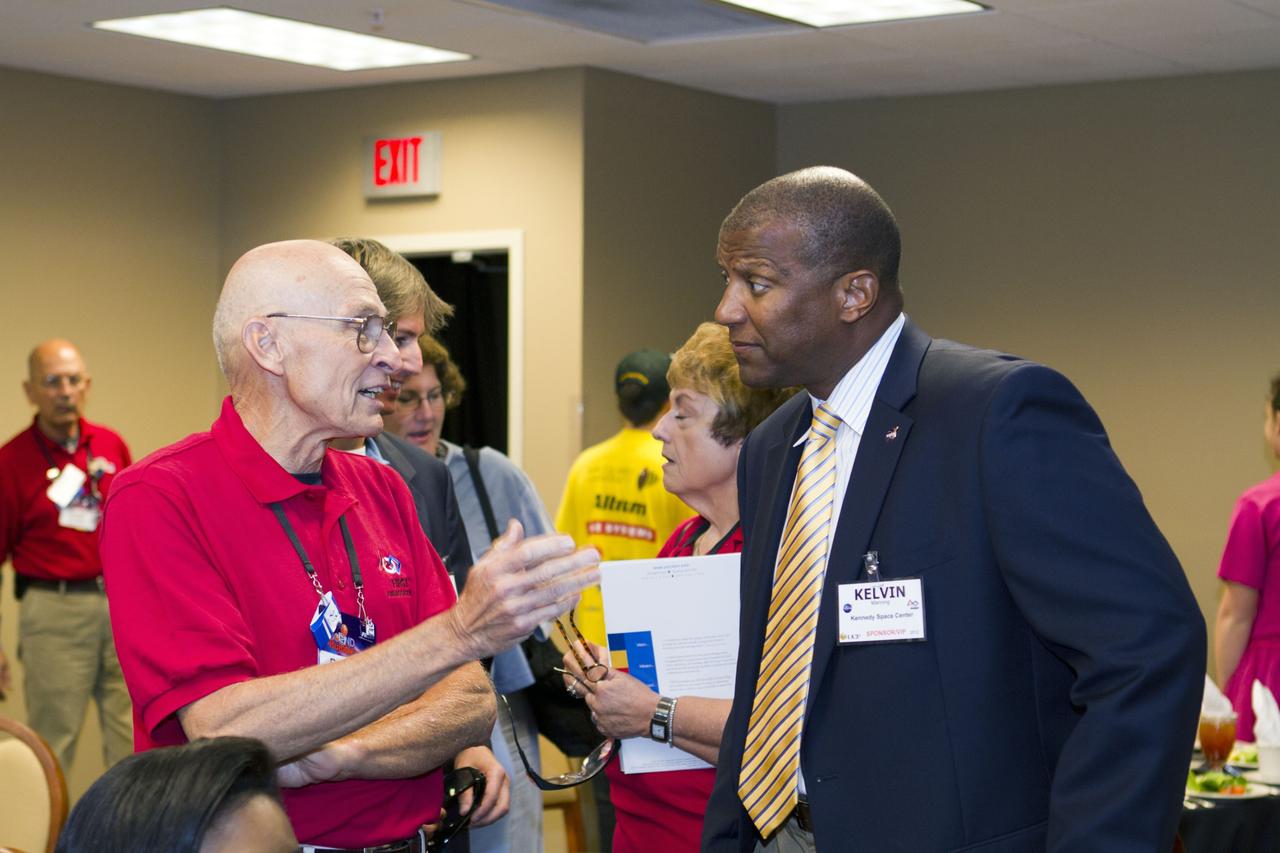 ORLANDO, Fla. -- Former space shuttle launch director, Bob Sieck, left, and NASA Kennedy Space Center Associate Director Kelvin Manning, right, talk amongst high school teams that are competing in the regional FIRST robotics competition at the University of Central Florida in Orlando, Fla. More than 60 teams took part in the competition called "For Inspiration and Recognition of Science and Technology," or FIRST, in hopes of advancing to the national robotics championship. This year, the competition resembled a basketball game and was dubbed "Rebound Rumble." The game measured the effectiveness of each robot, the power of collaboration and the determination of the teams.    FIRST, founded in 1989, is a non-profit organization that designs accessible, innovative programs to build self-confidence, knowledge and life skills while motivating young people to pursue academic opportunities. The robotics competition challenges teams of high school students and their mentors to solve a common problem in a six-week timeframe using a standard kit of parts and a common set of rules. NASA is the largest sponsor of the international program. Kennedy Space Center is a sponsor of the regional event. For more information on Kennedy's education events and initiatives, go to http://www.nasa.gov/offices/education/centers/kennedy/home/index.html. Photo credit: NASA/Kim Shiflett