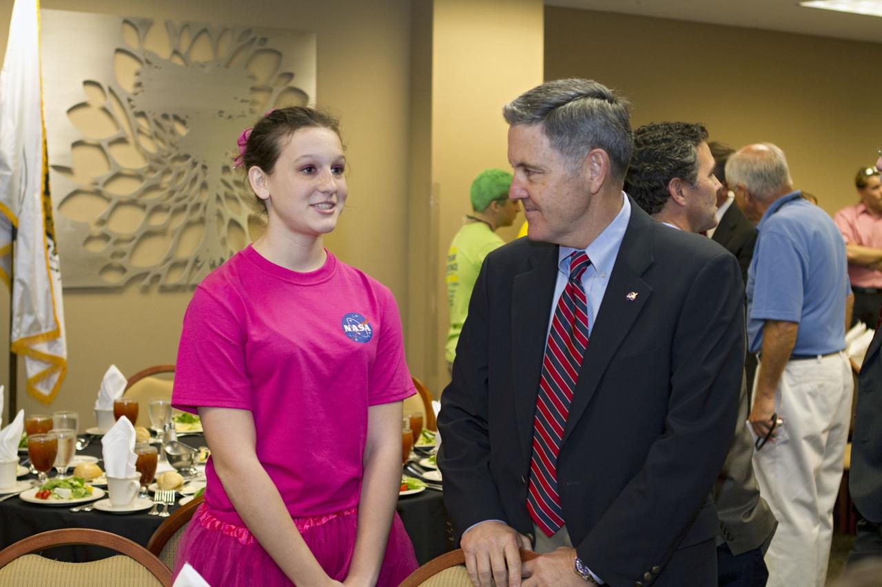ORLANDO, Fla. -- NASA Kennedy Space Center Director Bob Cabana talks with a member of Team 233, "The Pink Team," which is participating in the regional FIRST robotics competition at the University of Central Florida in Orlando, Fla. The team is made up of students from Rockledge, Cocoa Beach and Viera high schools along the Space Coast of Florida. Kennedy is a sponsor of the team. More than 60 teams took part in the competition called "For Inspiration and Recognition of Science and Technology," or FIRST, in hopes of advancing to the national robotics championship. This year, the competition resembled a basketball game and was dubbed "Rebound Rumble." The game measured the effectiveness of each robot, the power of collaboration and the determination of the teams.    FIRST, founded in 1989, is a non-profit organization that designs accessible, innovative programs to build self-confidence, knowledge and life skills while motivating young people to pursue academic opportunities. The robotics competition challenges teams of high school students and their mentors to solve a common problem in a six-week timeframe using a standard kit of parts and a common set of rules. NASA is the largest sponsor of the international program. Kennedy Space Center is a sponsor of the regional event. For more information on Kennedy's education events and initiatives, go to http://www.nasa.gov/offices/education/centers/kennedy/home/index.html. Photo credit: NASA/Kim Shiflett