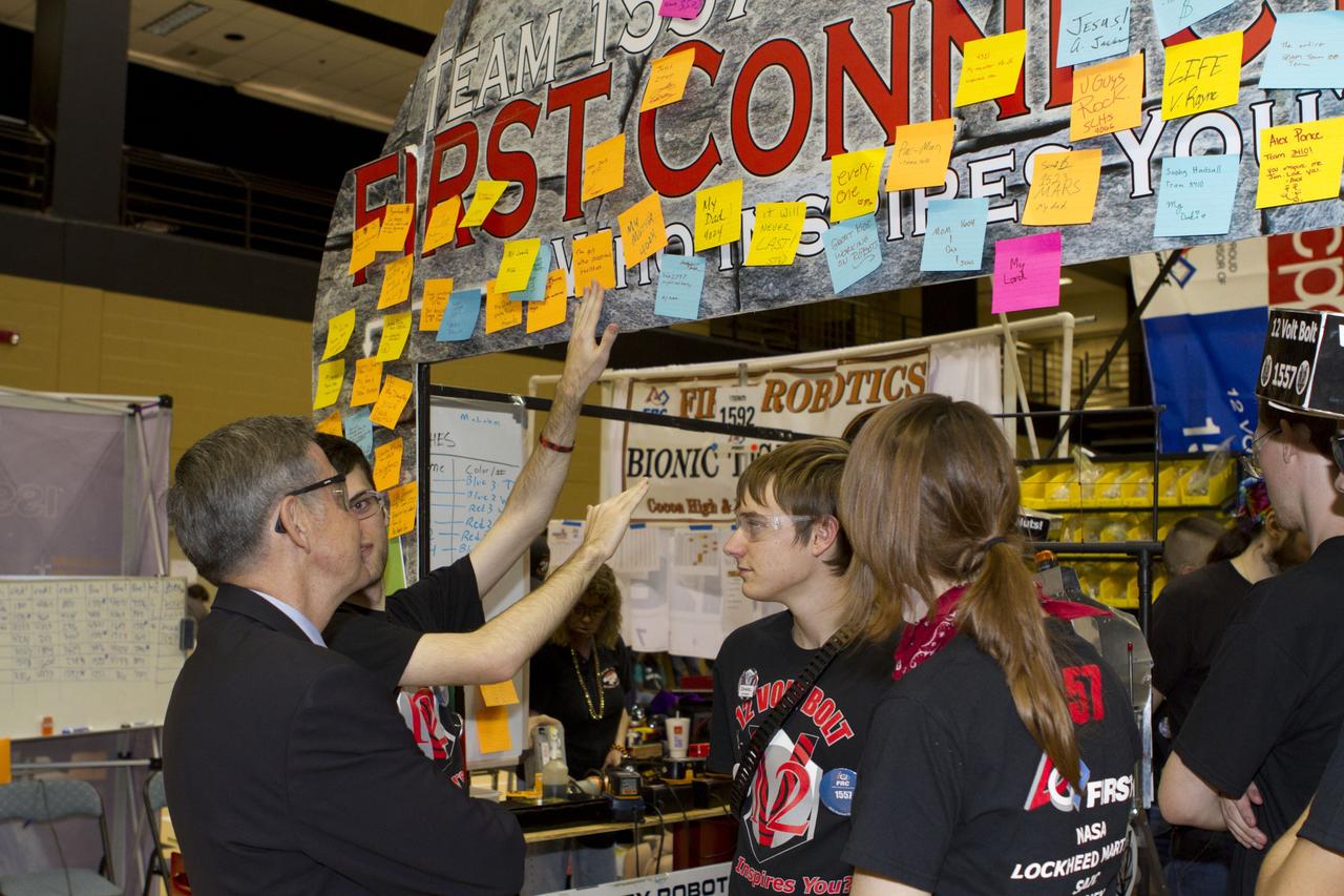 ORLANDO, Fla. -- NASA Kennedy Space Center Director Bob Cabana talks with members of the "12 Volt Bolt Team," which is participating in the regional FIRST robotics competition at the University of Central Florida in Orlando, Fla. The team is from Eustis, Fla., and consists of students from many Lake County schools, including Mt. Dora High, Eustis High, Tavares High, Mt. Dora Bible and homeschooled students. More than 60 high school teams took part in the competition called "For Inspiration and Recognition of Science and Technology," or FIRST, in hopes of advancing to the national robotics championship. This year, the competition resembled a basketball game and was dubbed "Rebound Rumble." The game measured the effectiveness of each robot, the power of collaboration and the determination of the teams.    FIRST, founded in 1989, is a non-profit organization that designs accessible, innovative programs to build self-confidence, knowledge and life skills while motivating young people to pursue academic opportunities. The robotics competition challenges teams of high school students and their mentors to solve a common problem in a six-week timeframe using a standard kit of parts and a common set of rules. NASA is the largest sponsor of the international program. Kennedy Space Center is a sponsor of the regional event. For more information on Kennedy's education events and initiatives, go to http://www.nasa.gov/offices/education/centers/kennedy/home/index.html. Photo credit: NASA/Kim Shiflett