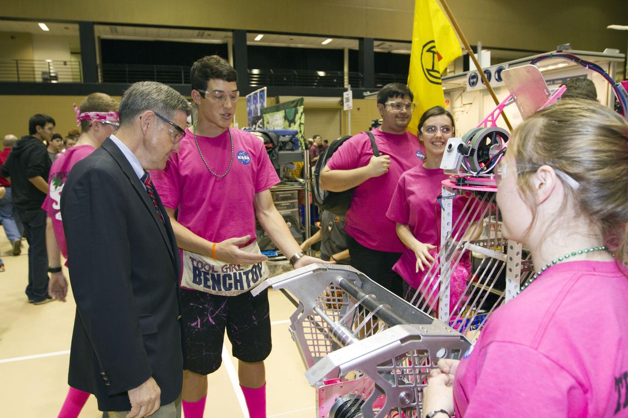 ORLANDO, Fla. -- NASA Kennedy Space Center Director Bob Cabana talks with members of Team 233, "The Pink Team," which is participating in the regional FIRST robotics competition at the University of Central Florida in Orlando, Fla. The team is made up of students from Rockledge, Cocoa Beach and Viera high schools along the Space Coast of Florida. Kennedy is a sponsor of the team. More than 60 high school teams took part in the competition called "For Inspiration and Recognition of Science and Technology," or FIRST, in hopes of advancing to the national robotics championship. This year, the competition resembled a basketball game and was dubbed "Rebound Rumble." The game measured the effectiveness of each robot, the power of collaboration and the determination of the teams.    FIRST, founded in 1989, is a non-profit organization that designs accessible, innovative programs to build self-confidence, knowledge and life skills while motivating young people to pursue academic opportunities. The robotics competition challenges teams of high school students and their mentors to solve a common problem in a six-week timeframe using a standard kit of parts and a common set of rules. NASA is the largest sponsor of the international program. Kennedy Space Center is a sponsor of the regional event. For more information on Kennedy's education events and initiatives, go to http://www.nasa.gov/offices/education/centers/kennedy/home/index.html. Photo credit: NASA/Kim Shiflett