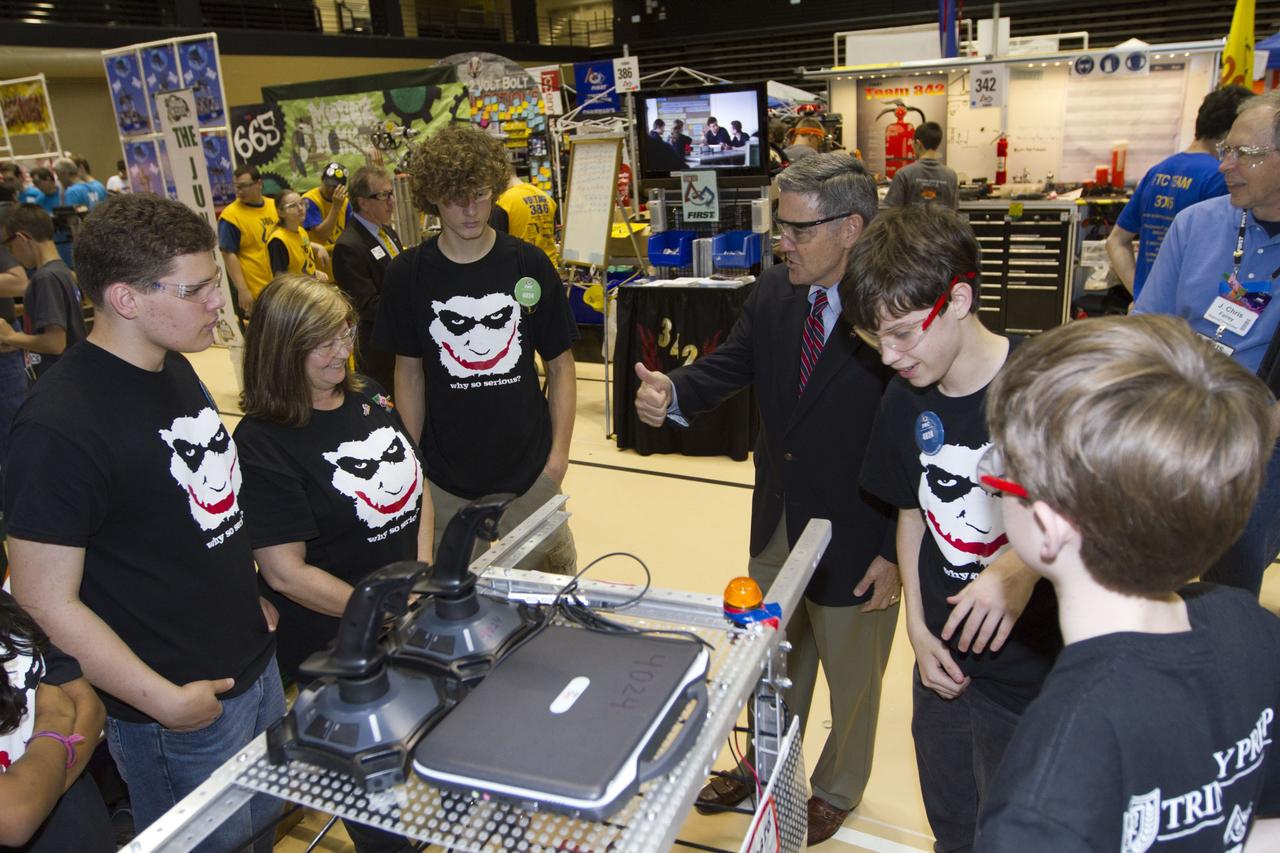 ORLANDO, Fla. -- NASA Kennedy Space Center Director Bob Cabana talks with members of Team 4024, which is participating in the regional FIRST robotics competition at the University of Central Florida in Orlando, Fla. The team is made up of students from Trinity Preparatory School in Winter Park, Fla. More than 60 high school teams took part in the competition called "For Inspiration and Recognition of Science and Technology," or FIRST, in hopes of advancing to the national robotics championship. This year, the competition resembled a basketball game and was dubbed "Rebound Rumble." The game measured the effectiveness of each robot, the power of collaboration and the determination of the teams.    FIRST, founded in 1989, is a non-profit organization that designs accessible, innovative programs to build self-confidence, knowledge and life skills while motivating young people to pursue academic opportunities. The robotics competition challenges teams of high school students and their mentors to solve a common problem in a six-week timeframe using a standard kit of parts and a common set of rules. NASA is the largest sponsor of the international program. Kennedy Space Center is a sponsor of the regional event. For more information on Kennedy's education events and initiatives, go to http://www.nasa.gov/offices/education/centers/kennedy/home/index.html. Photo credit: NASA/Kim Shiflett