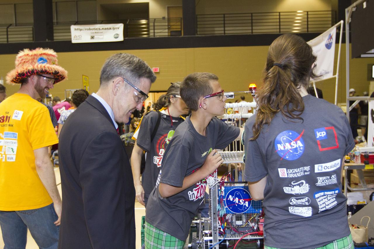ORLANDO, Fla. -- NASA Kennedy Space Center Director Bob Cabana talks with members of Team 4064, which is participating in the regional FIRST robotics competition at the University of Central Florida in Orlando, Fla. The team is made up of students from Vanguard High School in Ocala, Fla. More than 60 high school teams from throughout the country took part in the competition called "For Inspiration and Recognition of Science and Technology," or FIRST, in hopes of advancing to the national robotics championship. This year the competition resembled a basketball game and was dubbed "Rebound Rumble." The game measured the effectiveness of each robot, the power of collaboration and the determination of the teams.      FIRST, founded in 1989, is a non-profit organization that designs accessible, innovative programs to build self-confidence, knowledge and life skills while motivating young people to pursue academic opportunities. The robotics competition challenges teams of high school students and their mentors to solve a common problem in a six-week timeframe using a standard kit of parts and a common set of rules. NASA is the largest sponsor of the international program. Kennedy Space Center is a sponsor of the regional event. For more information on Kennedy's education events and initiatives, go to http://www.nasa.gov/offices/education/centers/kennedy/home/index.html. Photo credit: NASA/Kim Shiflett